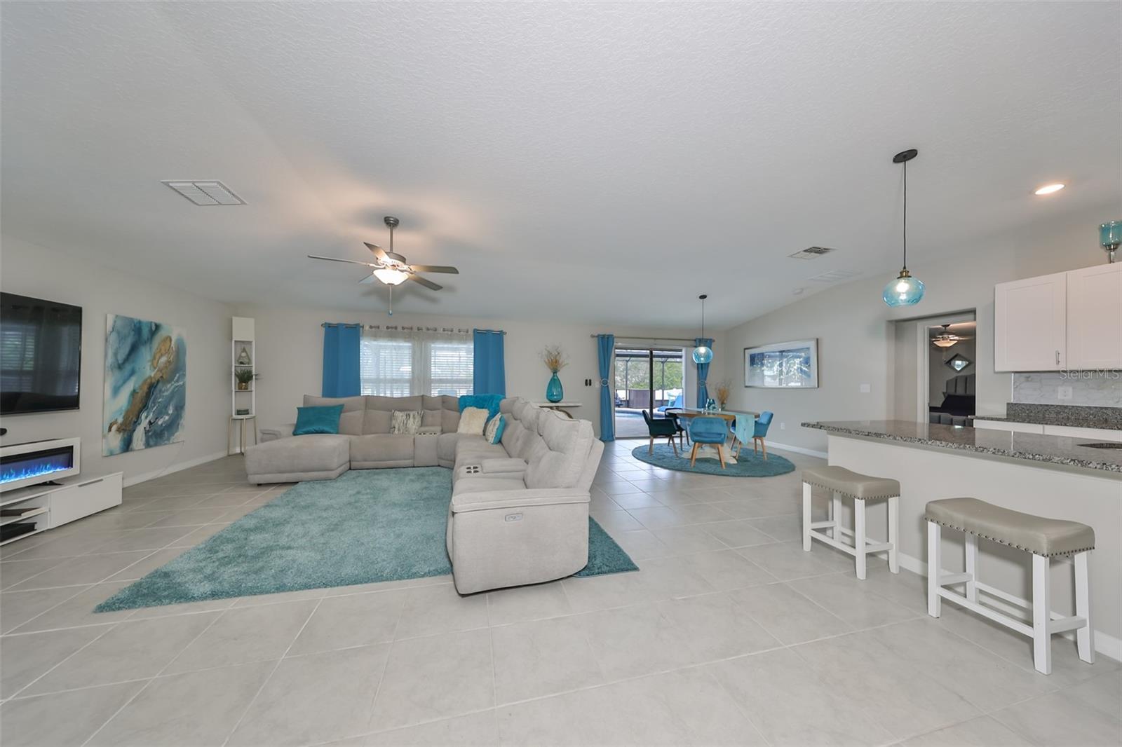 Expansive Great Room, kitchen and dinette - sliders and pool view!