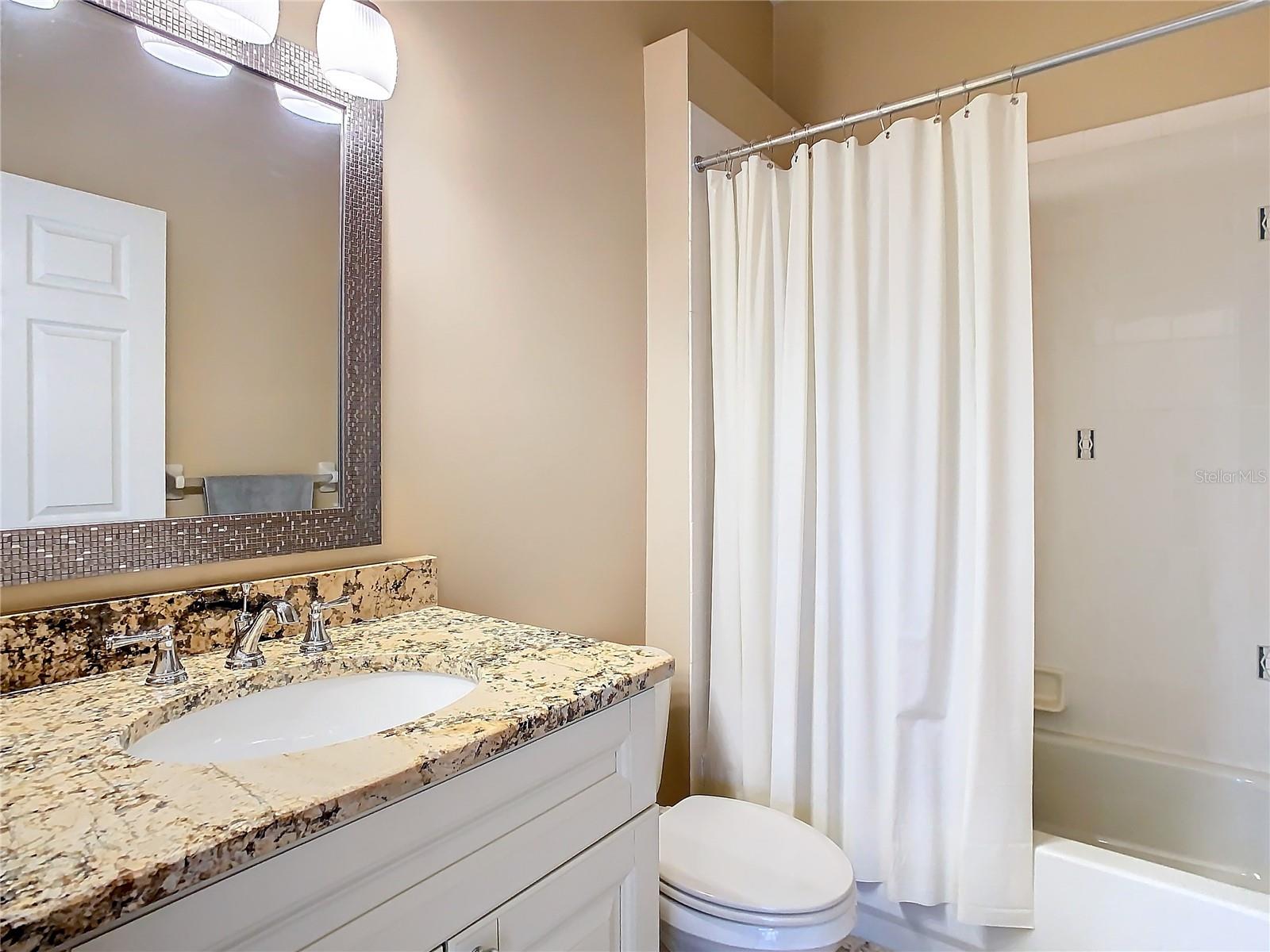 Easily accessible second bathroom located between the kitchen and second bedroom.