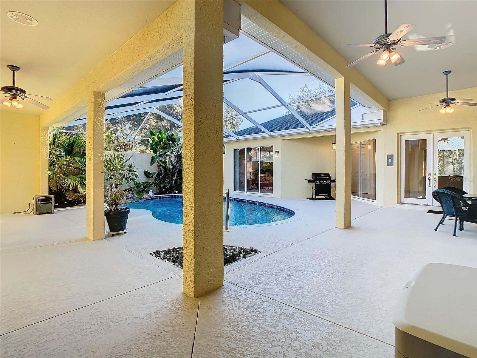 Be greeted by a picturesque pool view as you enter this inviting courtyard.