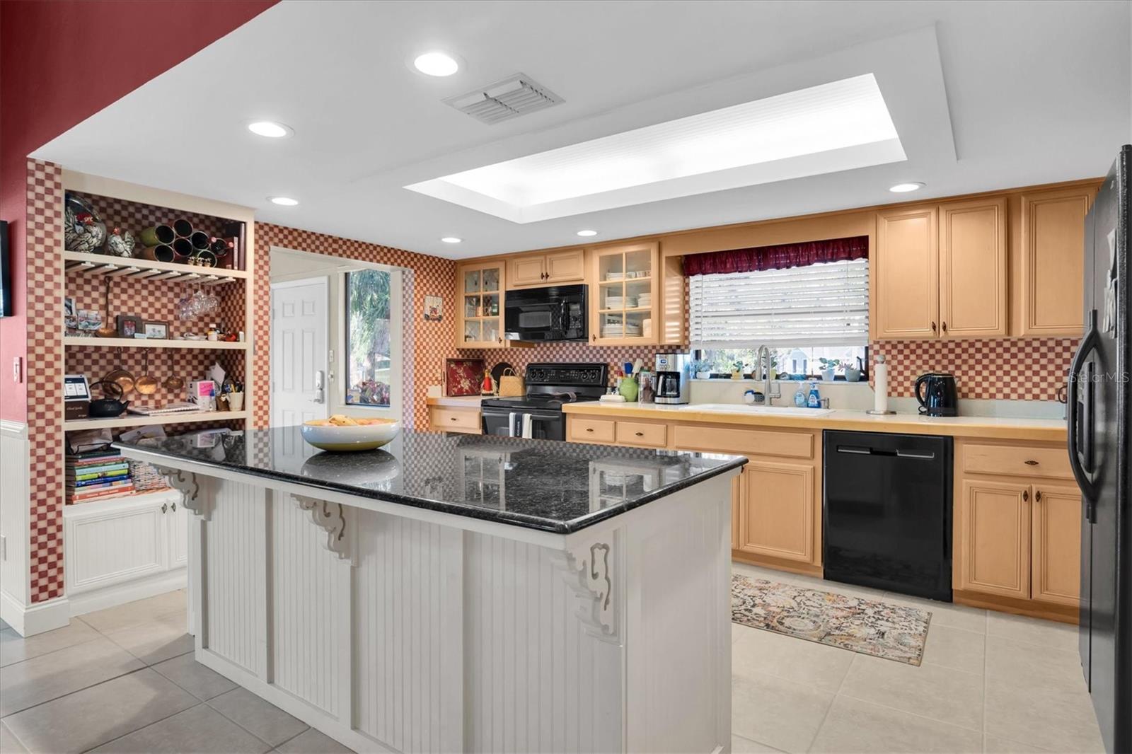 Kitchen with island and canned/tray lighting