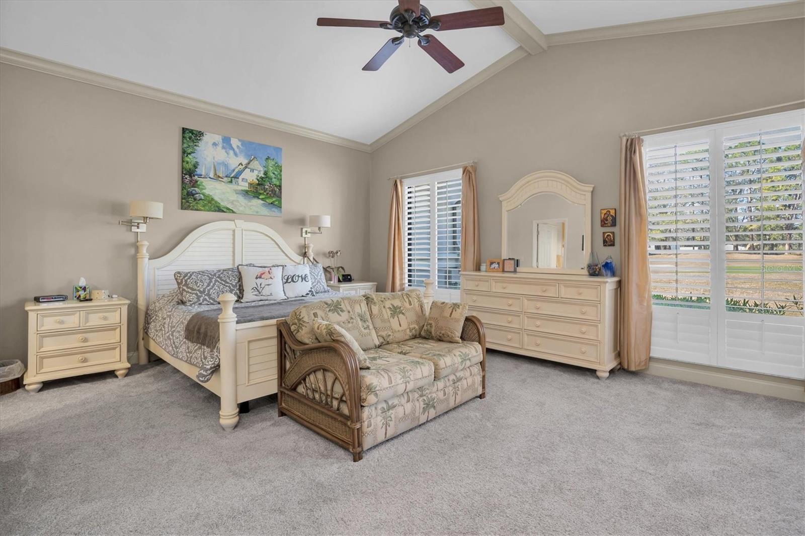 Primary bedroom with vaulted ceilings