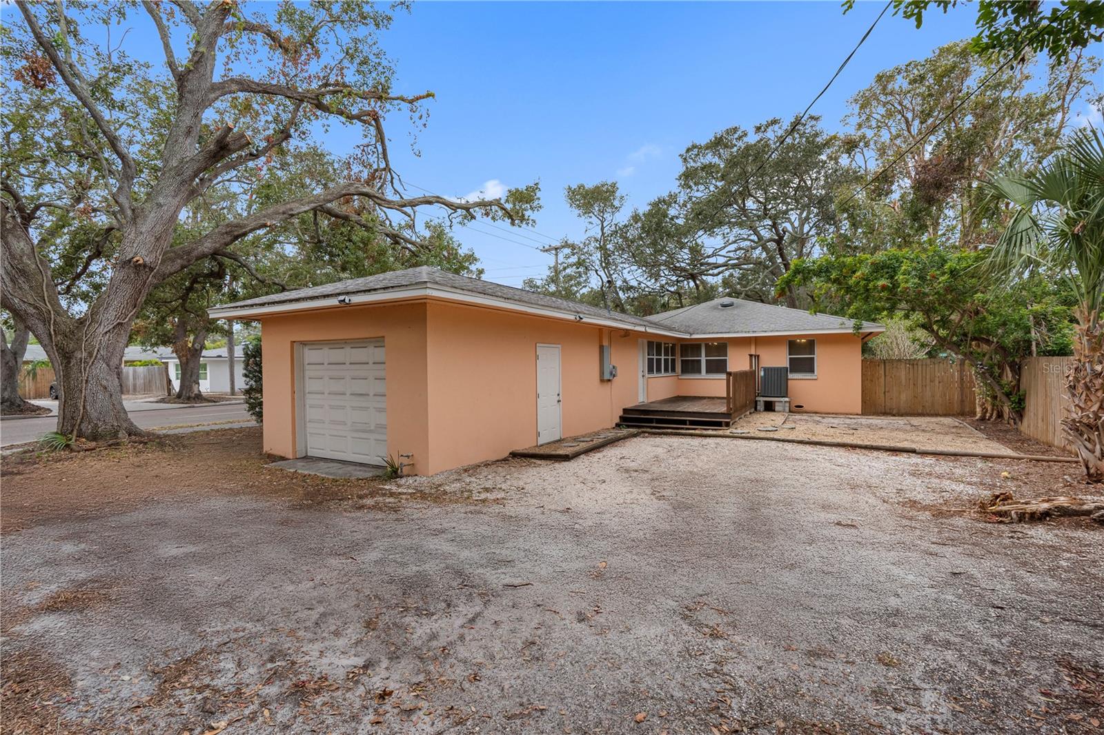 Backyard alley access, one car garage and deck patio.