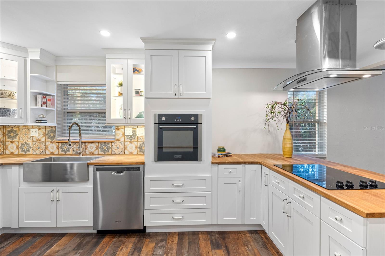 Farm sink, new cabinets, stainless hood vent, pendant lighting.