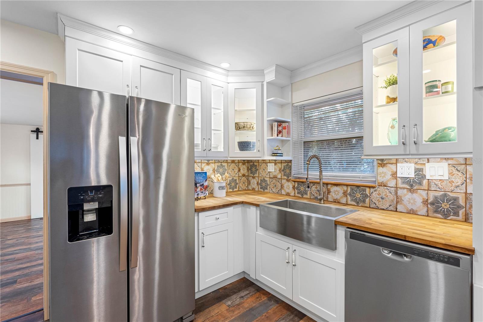 Upgraded tile backsplash, lit cabinets.