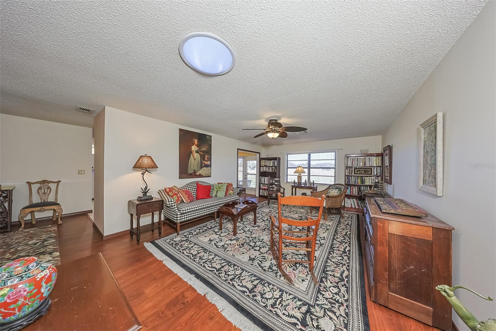 Living Room overlooks a vast green space of the retired executive section of the Specter Golf Course.   A solar tube, in the ceiling, allows additional exterior natural light into the large living room.