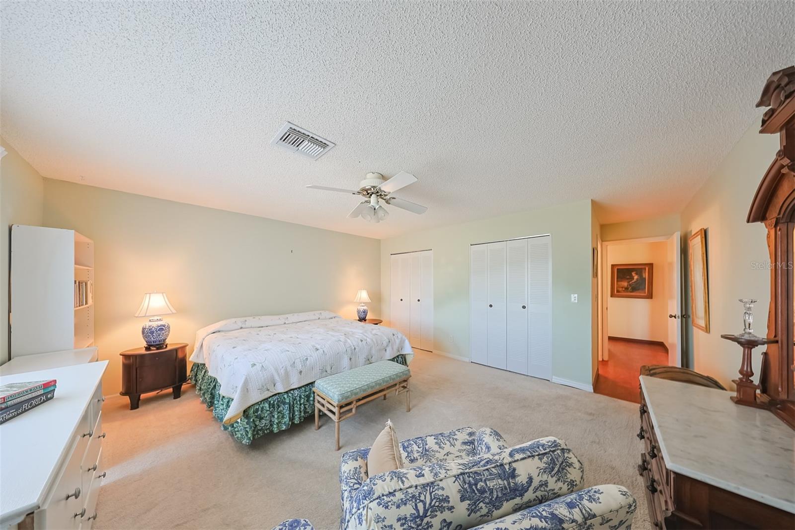 Owners ensuite  has double wall closets and is flooded with lots of natural Florida sunshine.  This space is incredible with room for a king bed, reading area and lots of additional furniture.