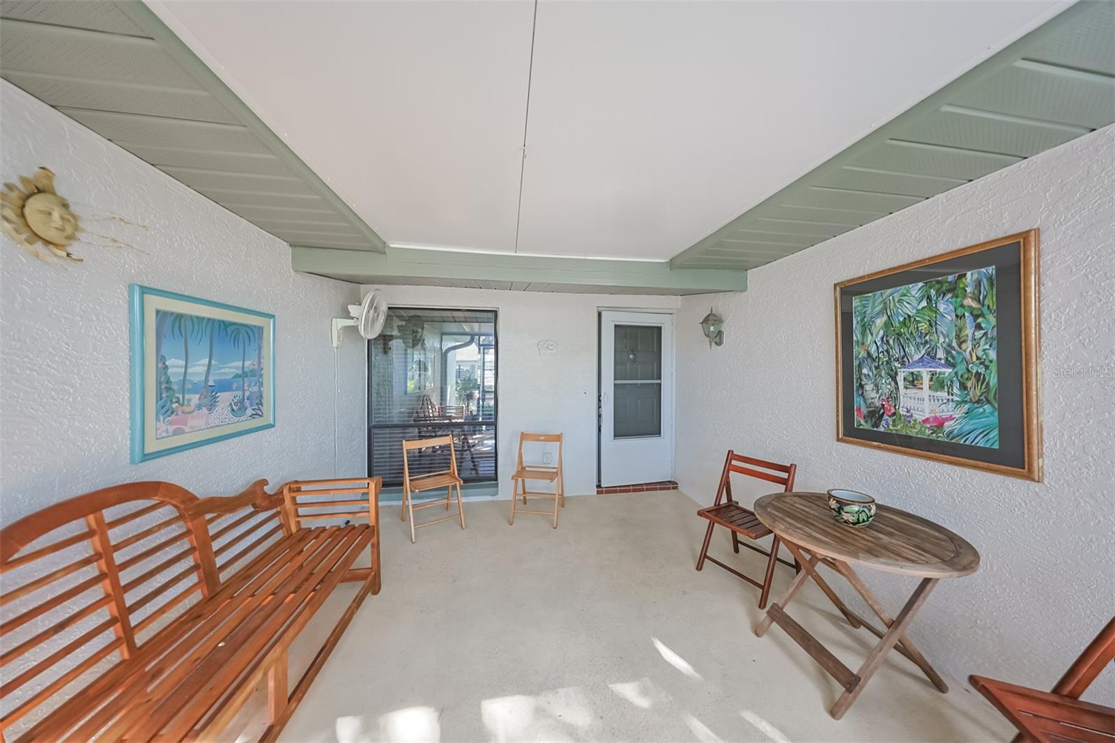 Enjoy the enclosed, screened, outdoor lanai year-round regardless of the weather.  There is even a wall fan, just in case the sea breezes aren't breezy enough.