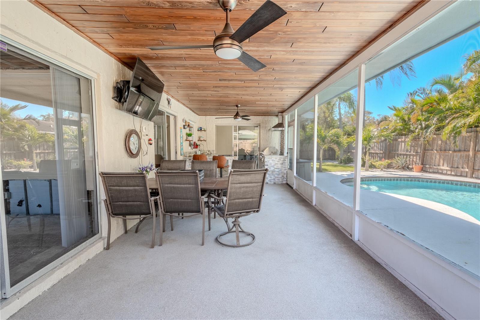 The screened in lanai features a beautiful tongue and groove ceiling with 2 ceiling fans for year round comfort.