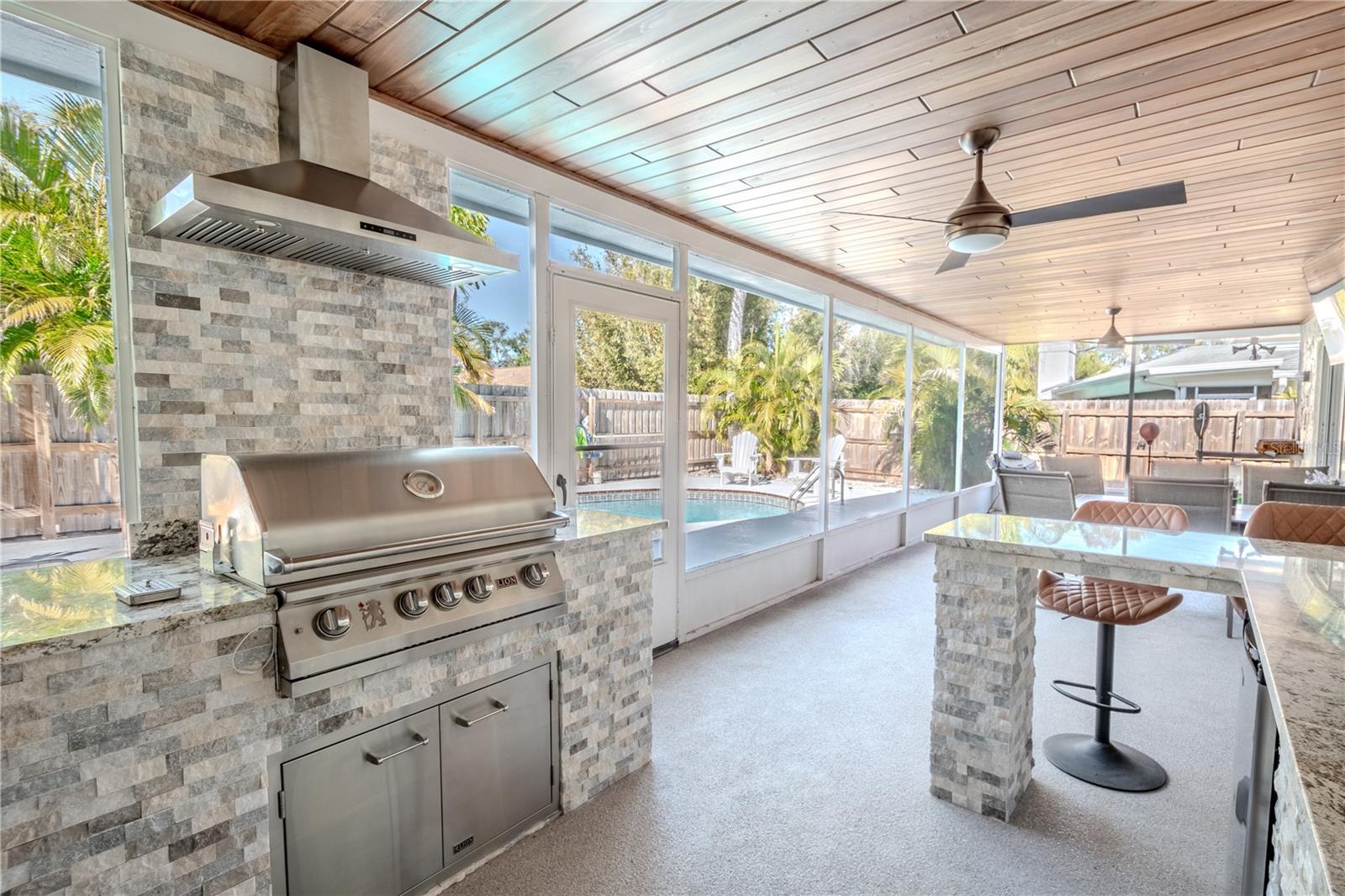 The outdoor kitchen features a Lion Gas Grill with superior craftsmanship, blending durability, functionality, and style.