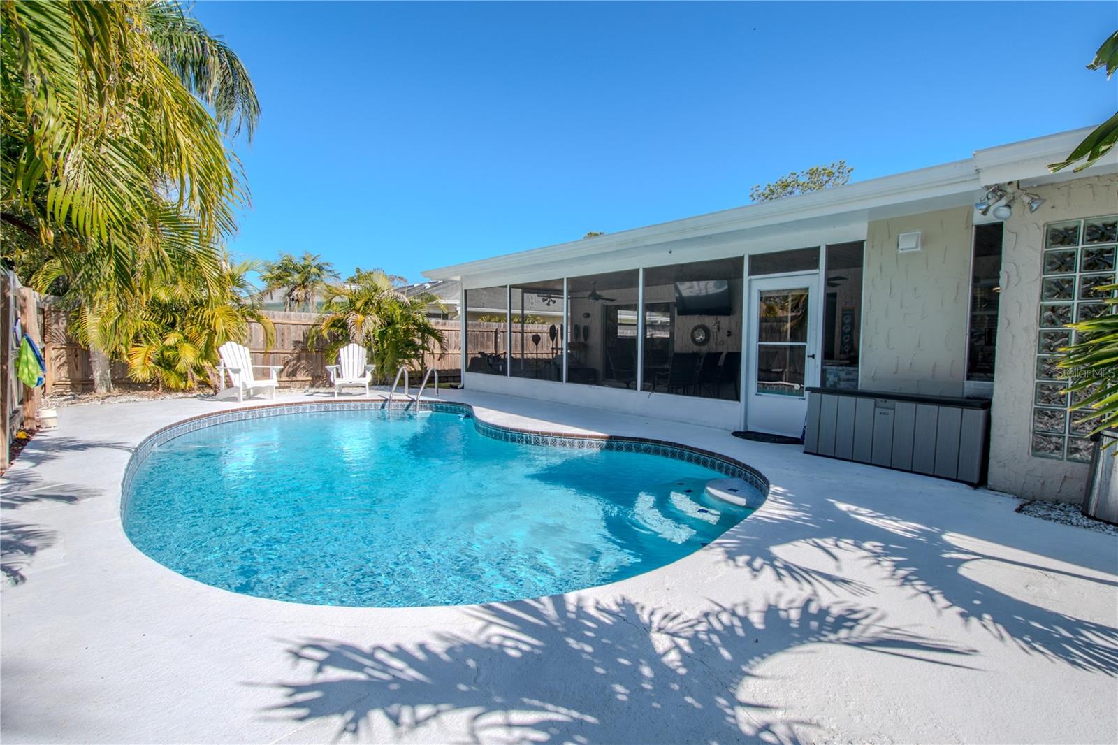 Step into the private pool in a tropical setting.