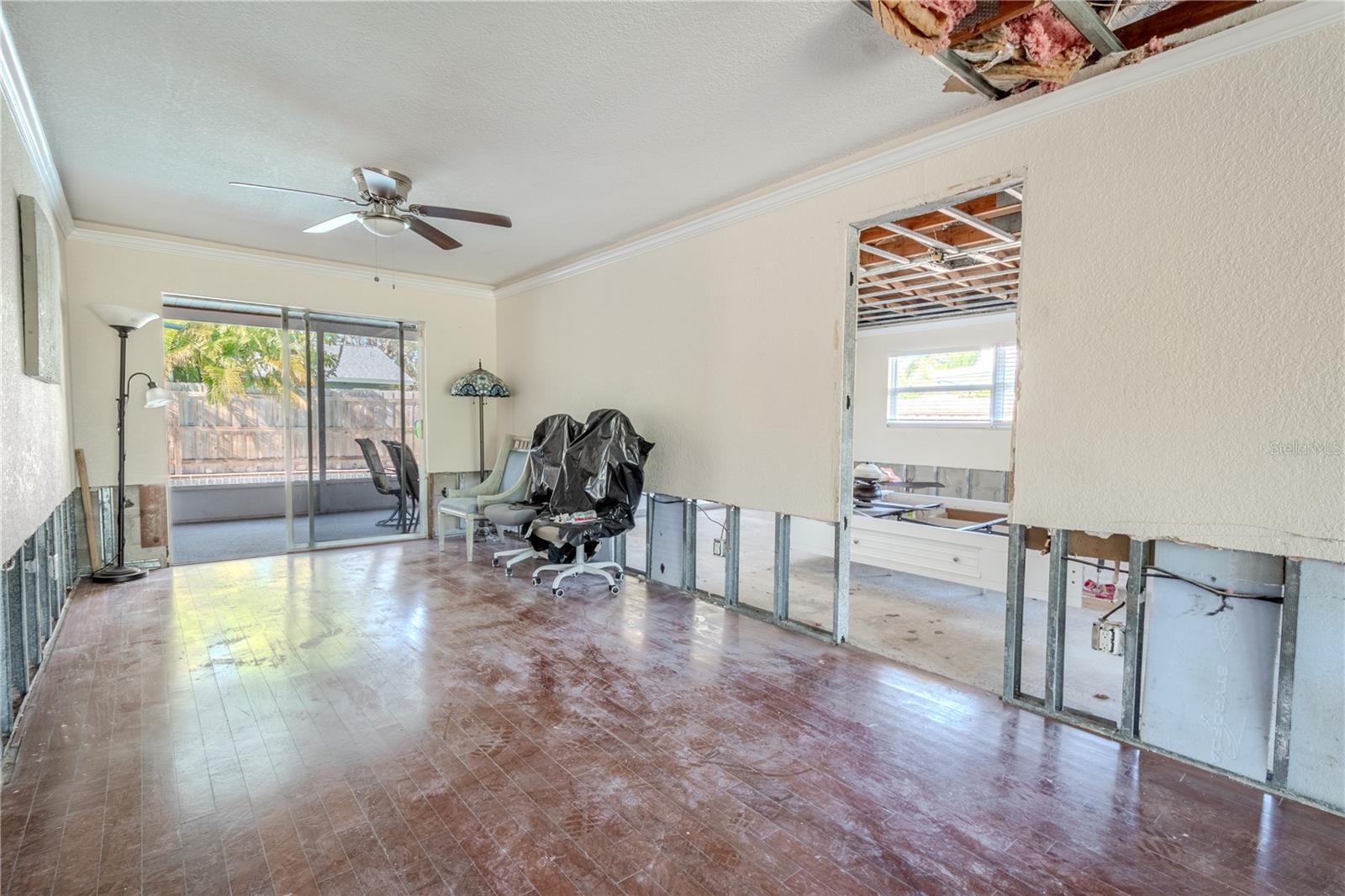 The Dining room has a ceiling fan and sliding glass doors that lead to the screen in lanai and outdoor kitchen.