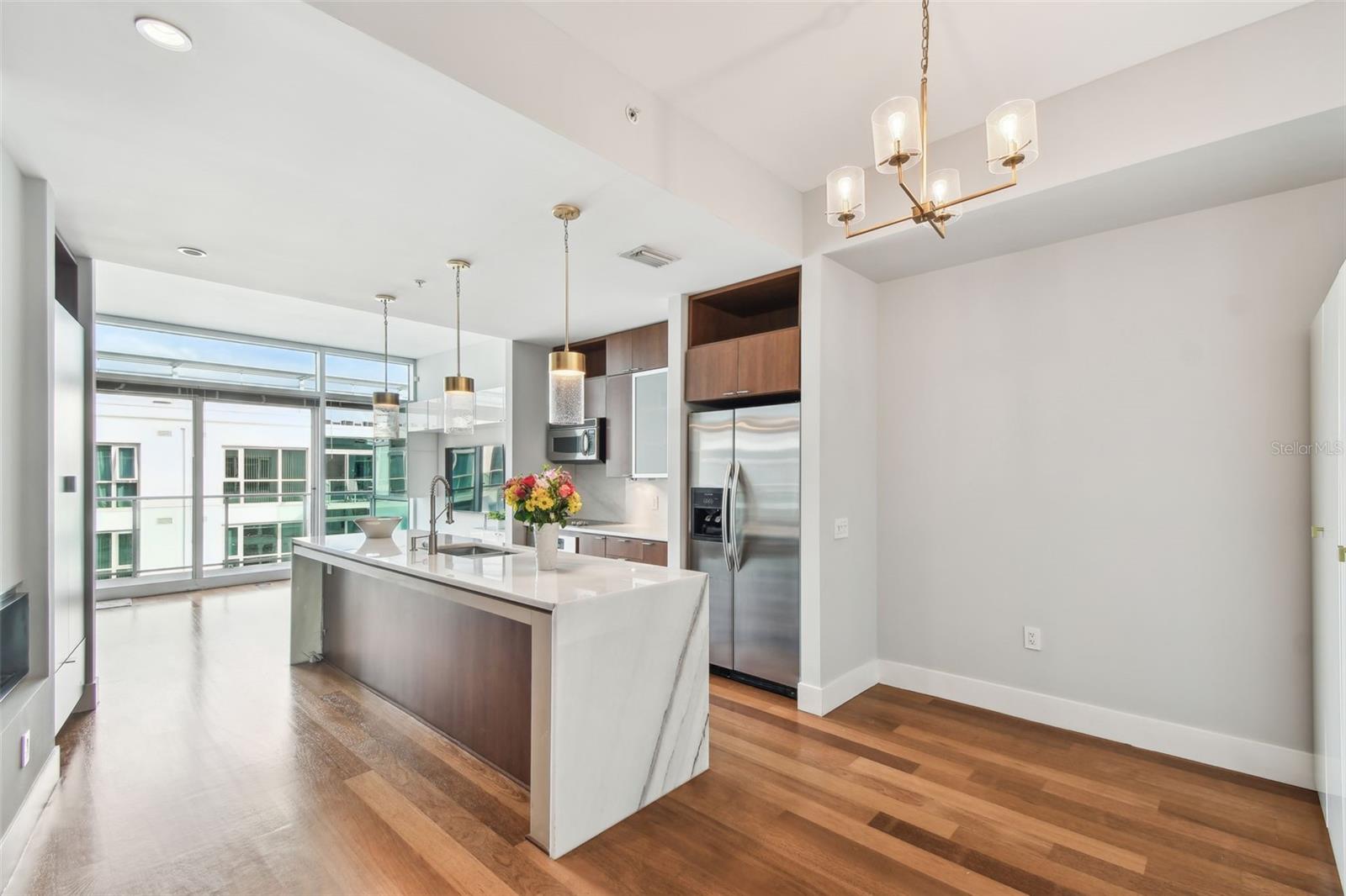 Dining and kitchen area featuring stainless steel appliances, and oversized island.