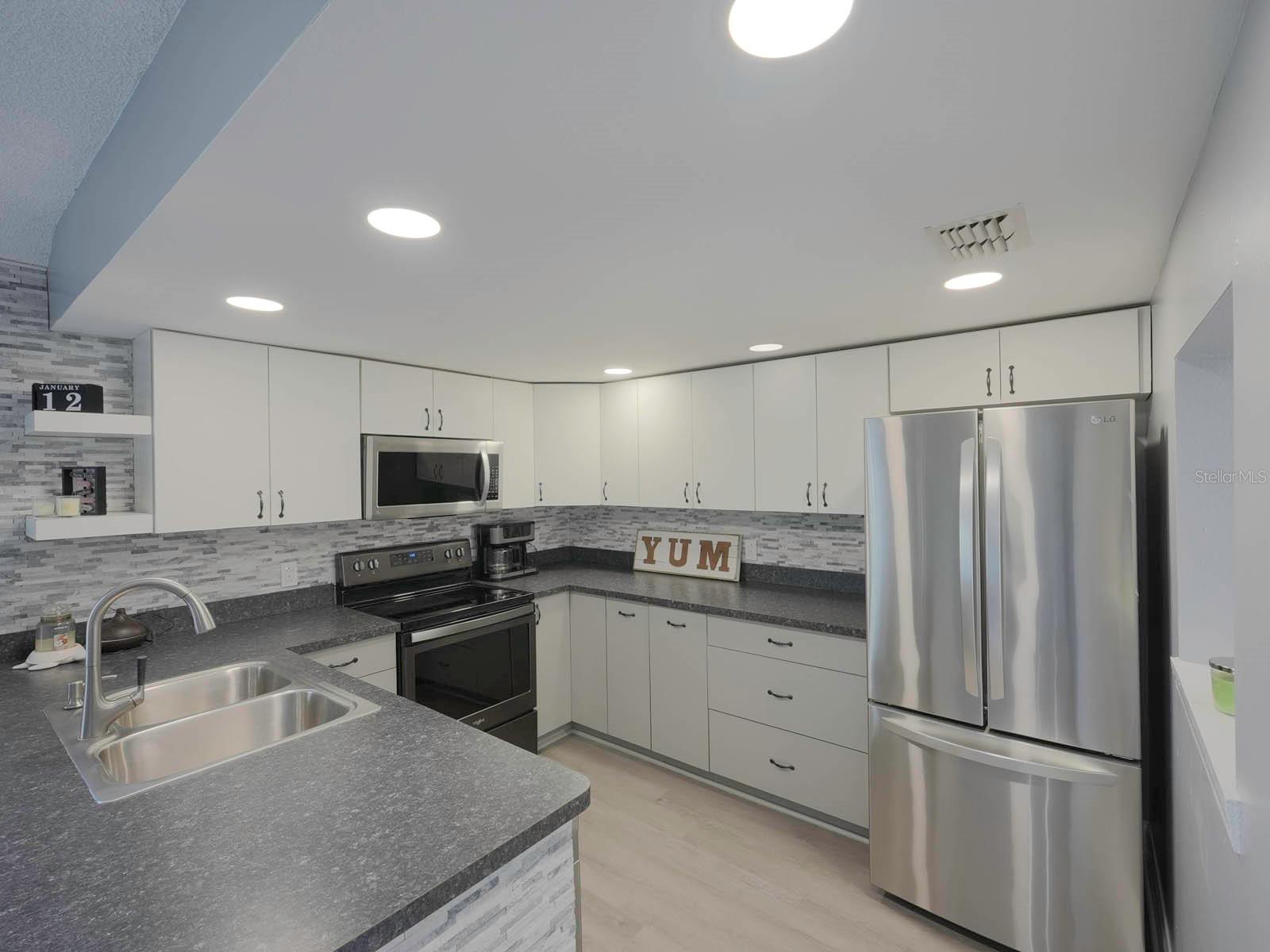 Modern Kitchen w/Stainless Steel Appliances & Backsplash