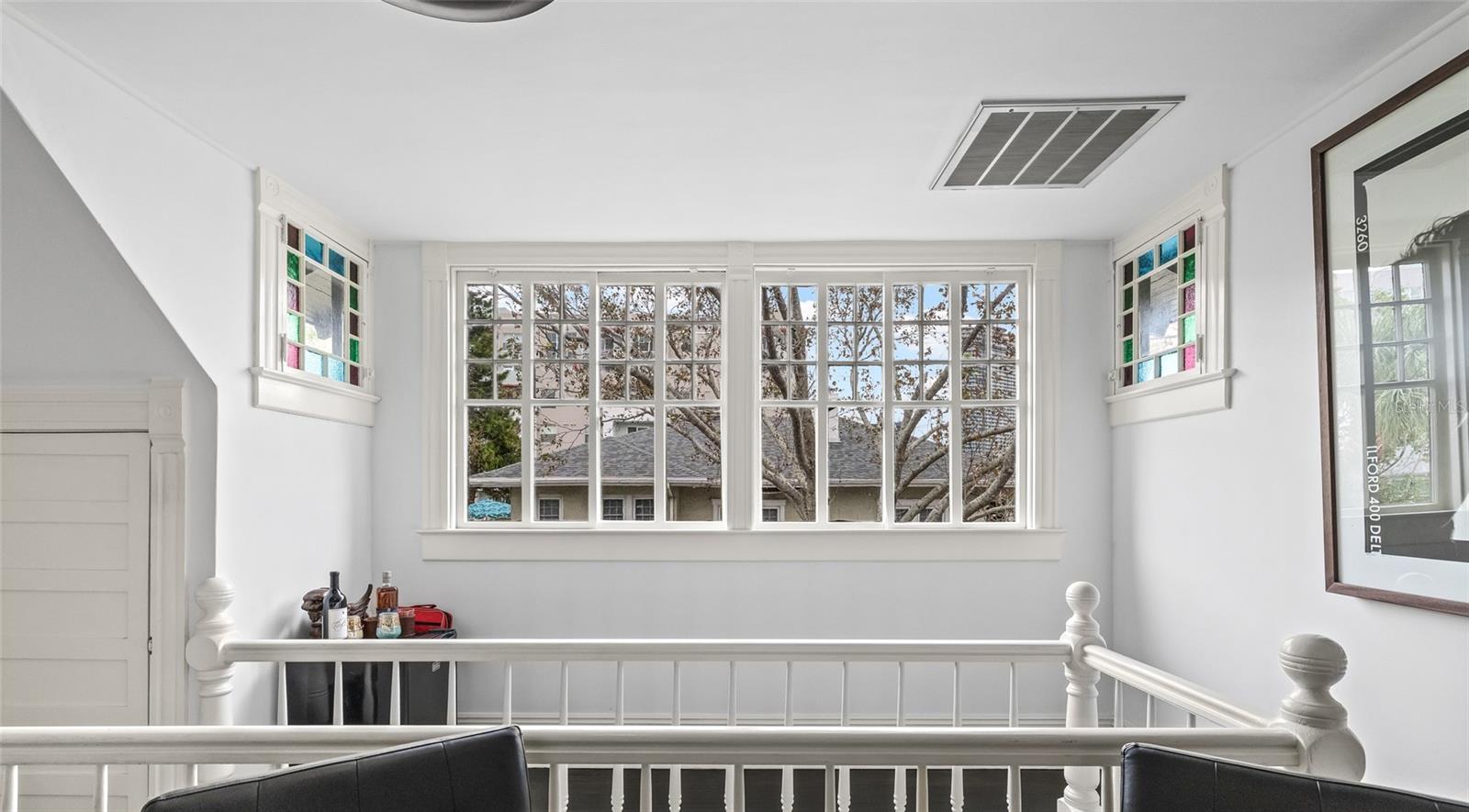 There is extra space at the top of the stairwell, and beautiful windows allow tons of natural light to come in!