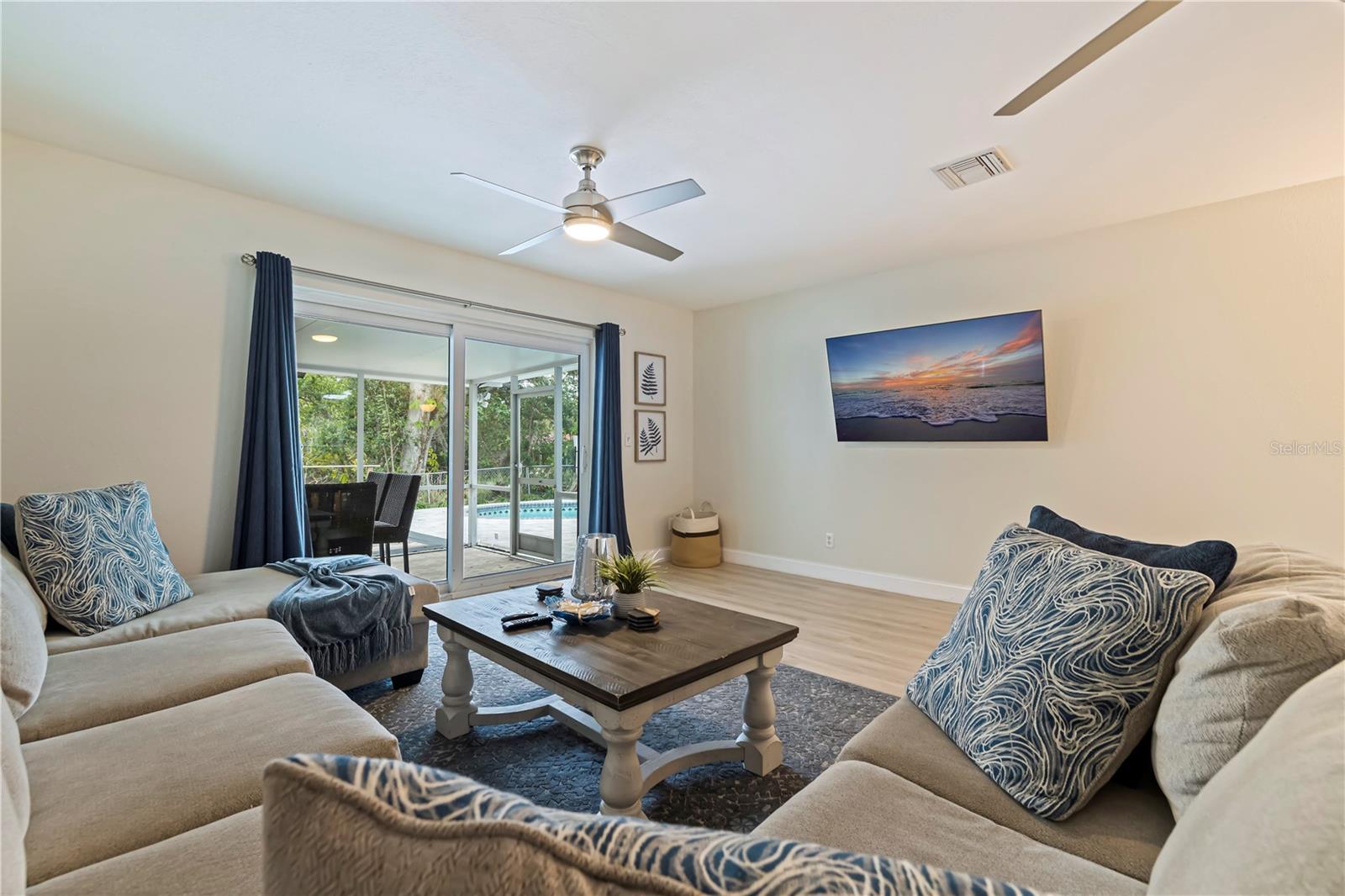 Huge family room with sliders to the screened in porch and pool.