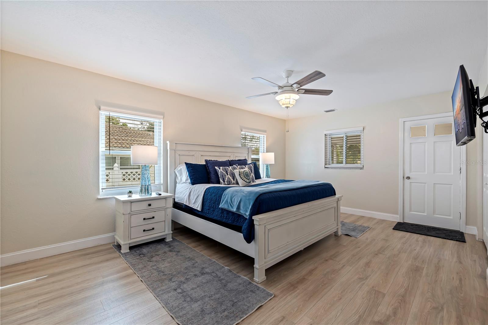 Primary bedroom with private access to the screened porch and pool areas.