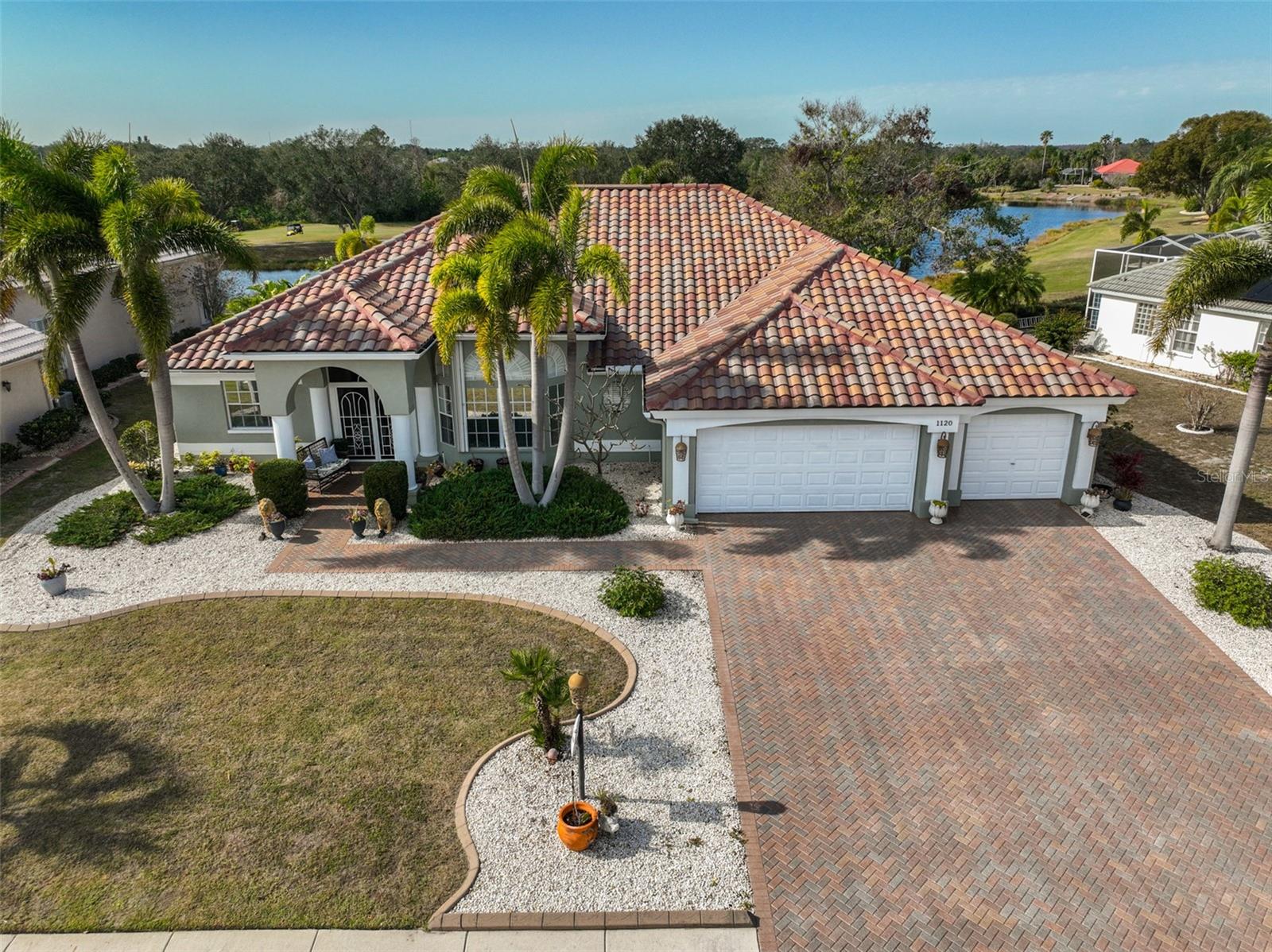 Aerial Front, 2022 Tile Roof, 3 Car Garage, Brick Paved & Sealed Driveway