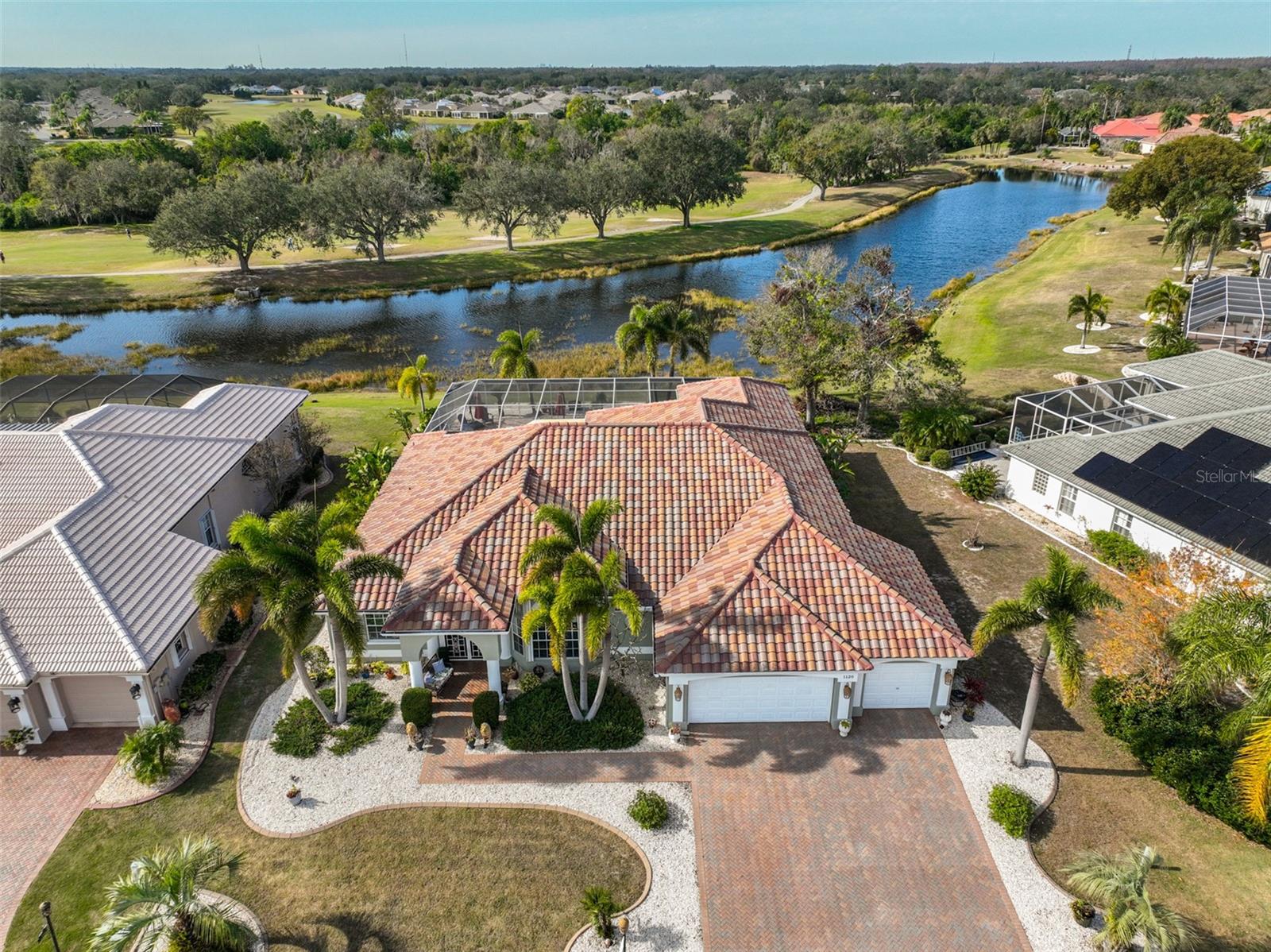 Aerial Front, 2022 Tile Roof, 3 Car Garage, Brick Paved & Sealed Driveway