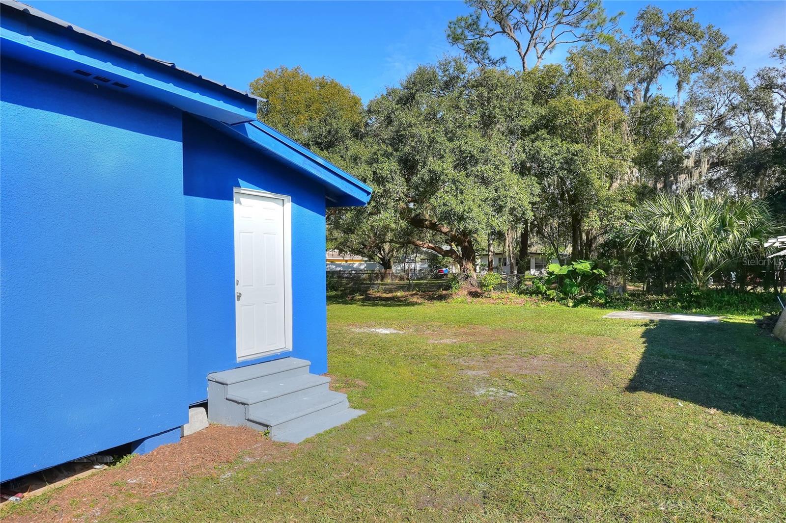 Back door leads to side-yard and backyard