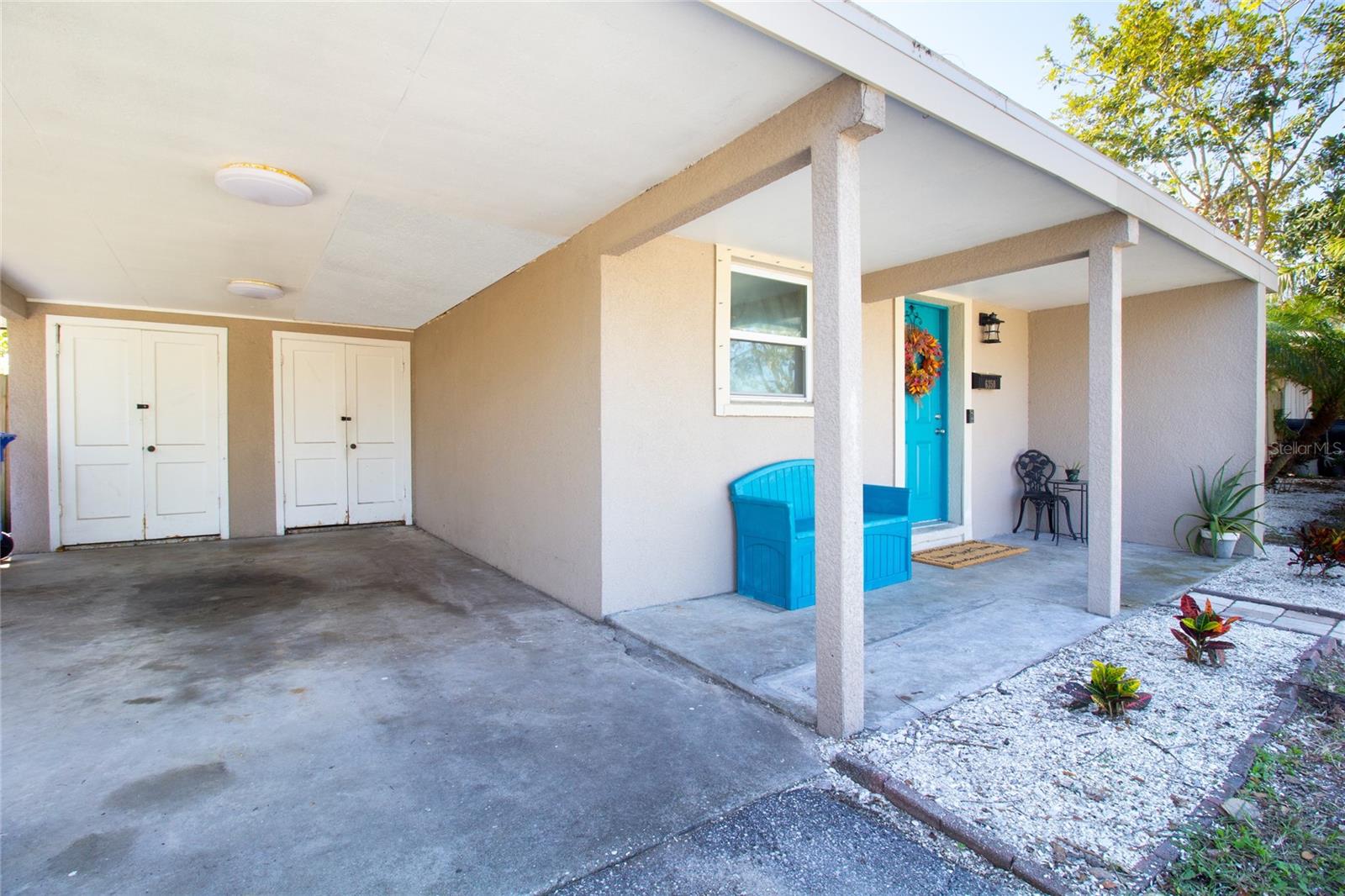 Carport featuring plenty of space and storage area.