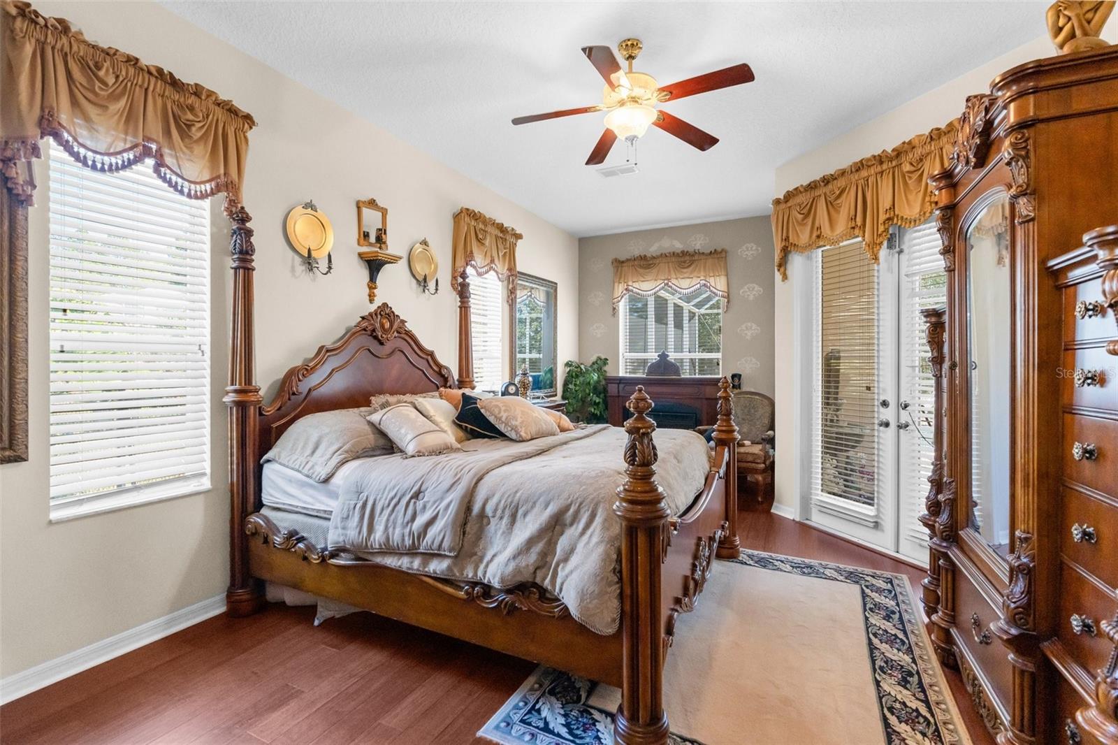 Master Bedroom with sitting area overlooking the pool with french doors to the pool, too!