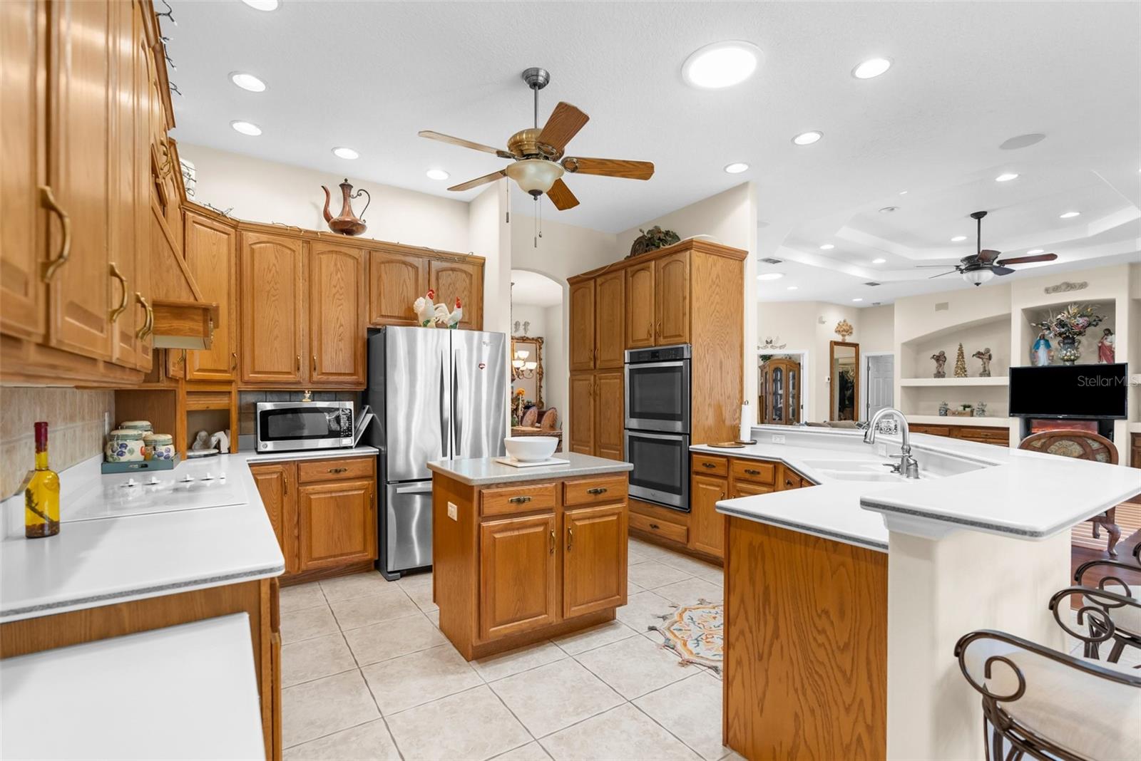 Large island kitchen with real wood cabinets and Corian countertops.