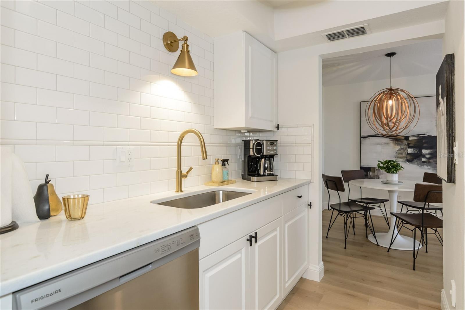 White marble countertops and subway tile wall