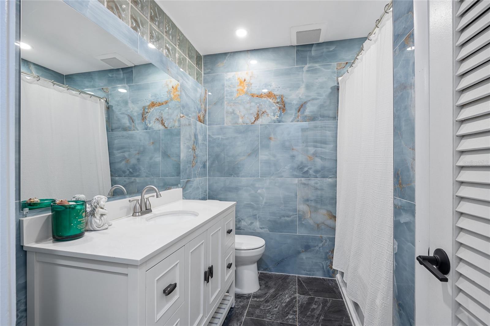 The Guest Bathroom has also been fully renovated and features a large single sink Vanity