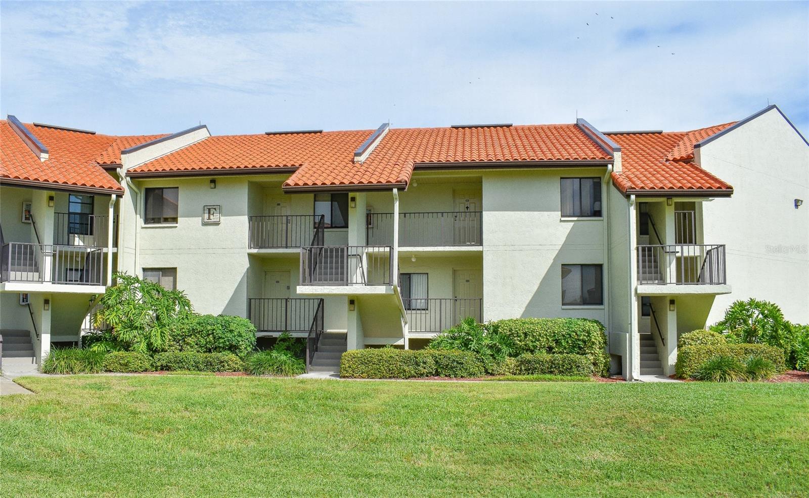 Back of Building showing upper level balcony to unit