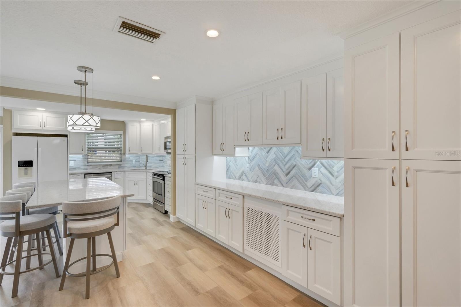 Island Kitchen with Additional Cabinets and Countertop Workspace