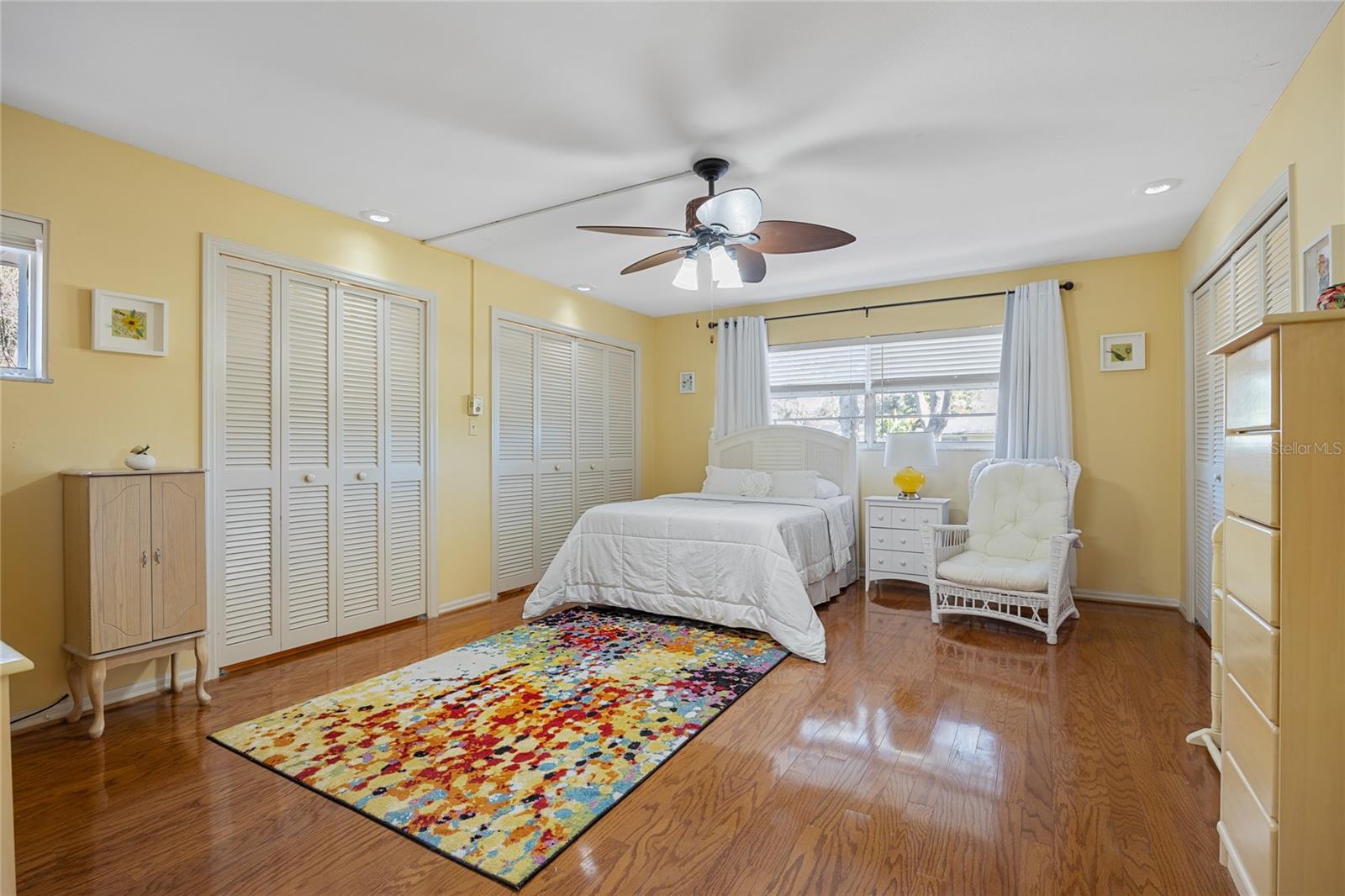 The ground-floor bedroom features an en suite bathroom and an abundance of closet space, offering both comfort and convenience.