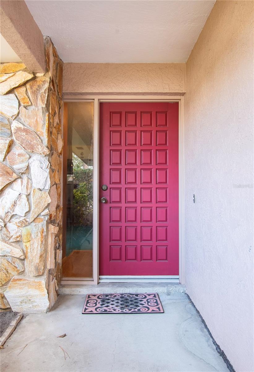 Greeted by a long, inviting covered porch, creating a warm first impression.