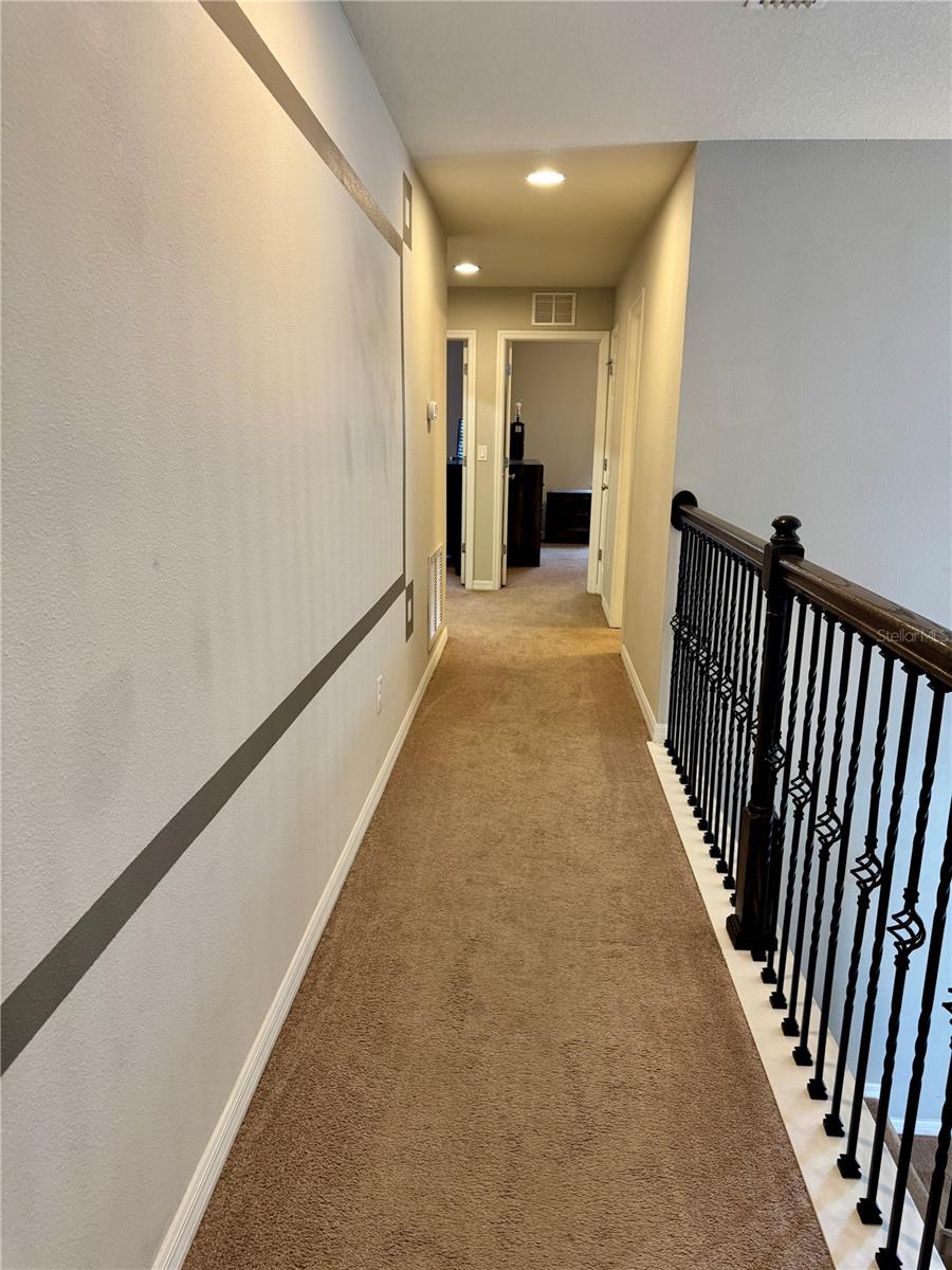 Hallway to split bedroom floor plan