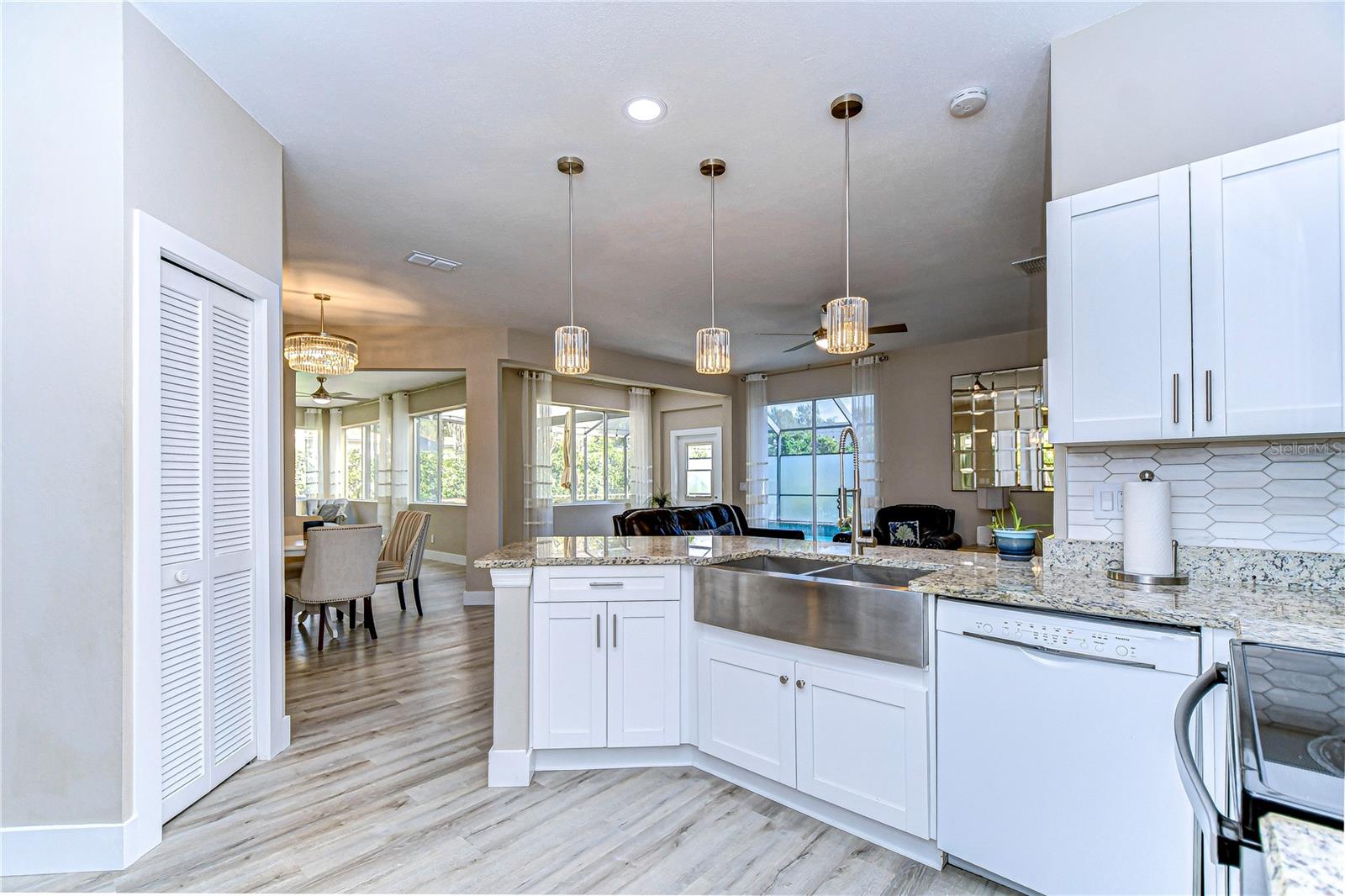 Large open kitchen leading into the spacious living area with beautiful statement lighting.