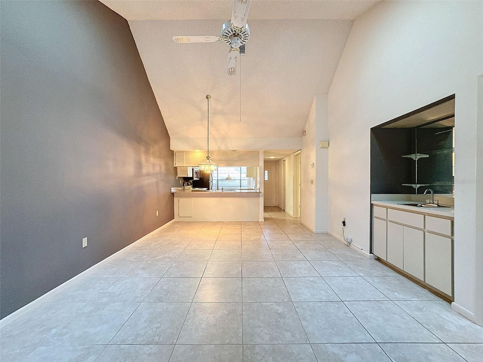 Living/Dining Area with wet bar looking into Kitchen