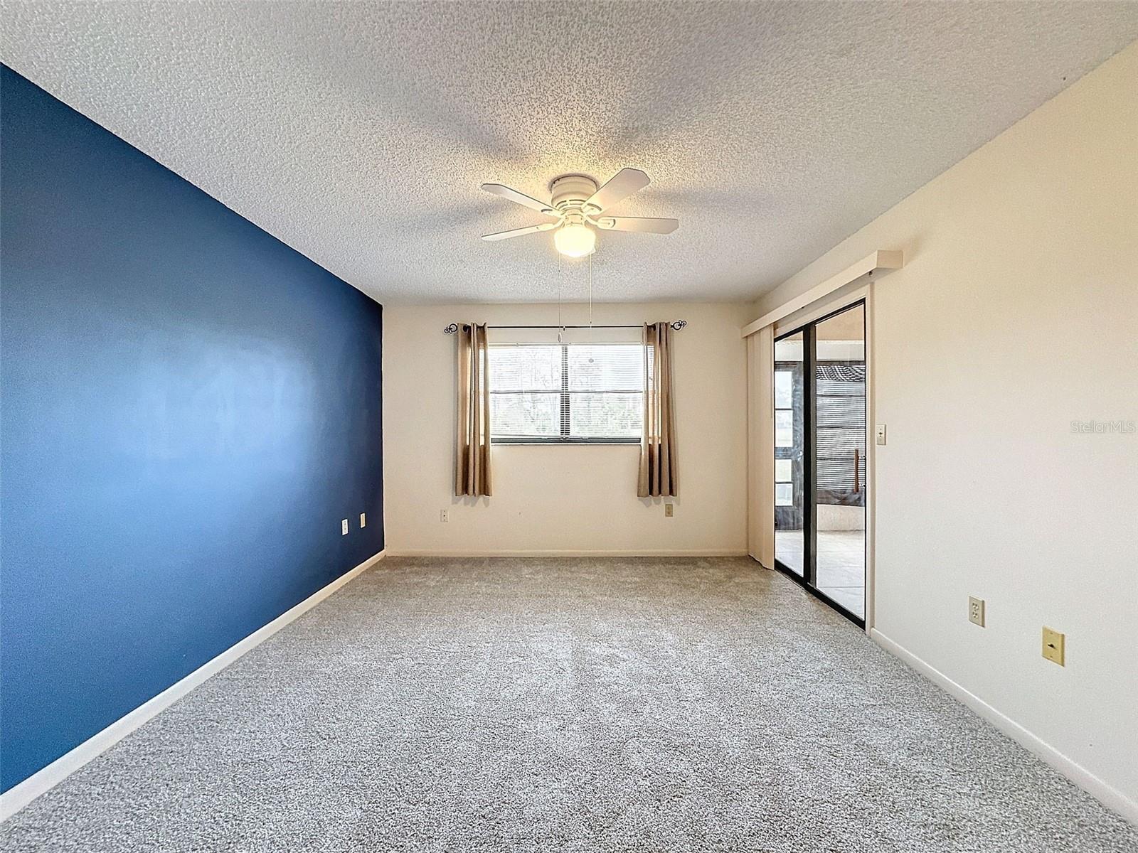 Primary En-Suite with sliding glass doors to back patio