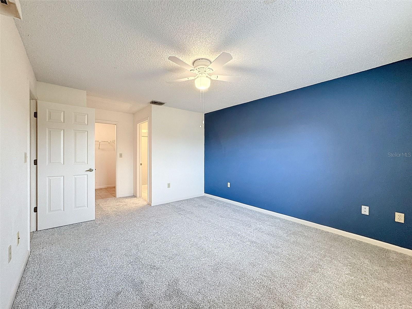 Primary En-Suite with sliding glass doors to back patio