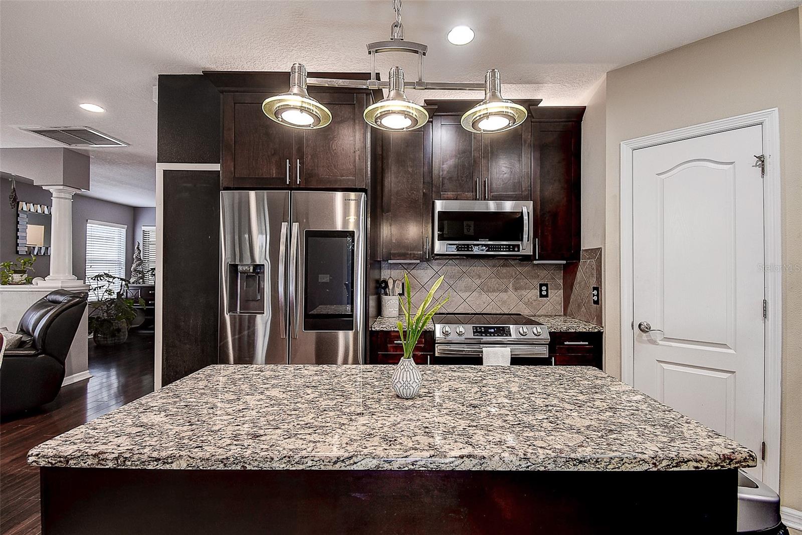 Large island and walk-in pantry that goes around under the stairs for tons of storage