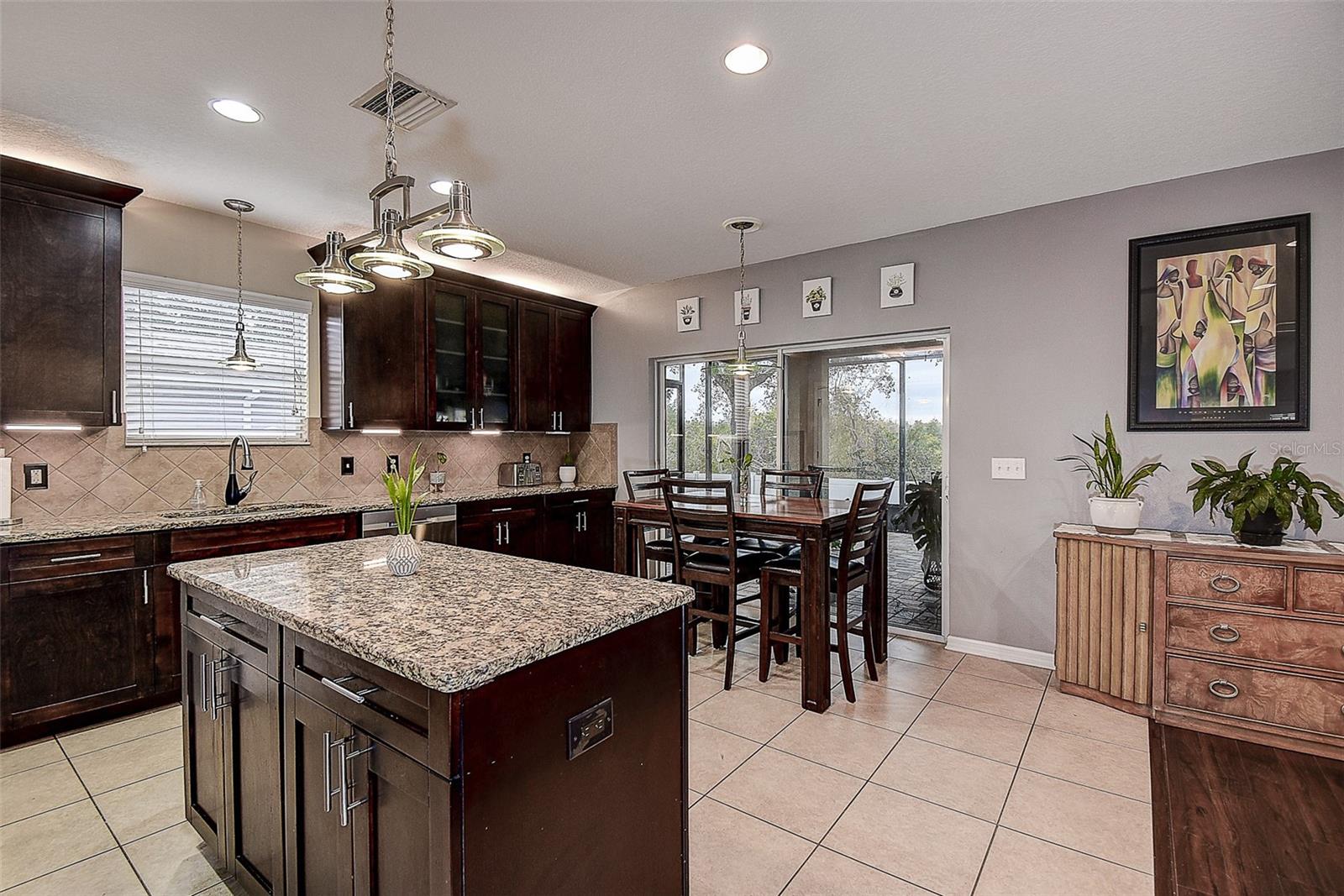 Kitchen has sliding doors leading out to screened lanai