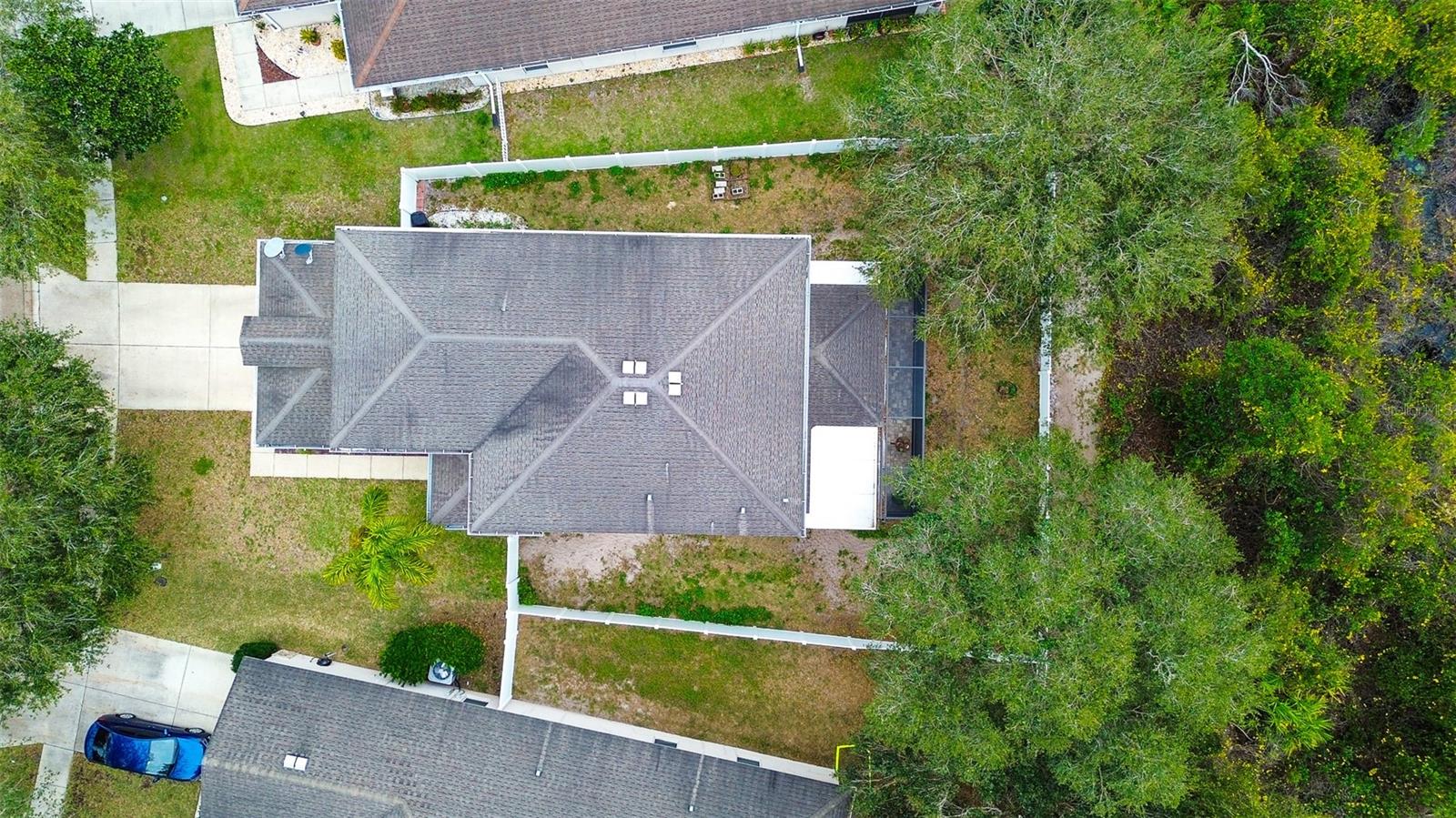 Layout of house on fenced yard.  Trees on either corner of the property