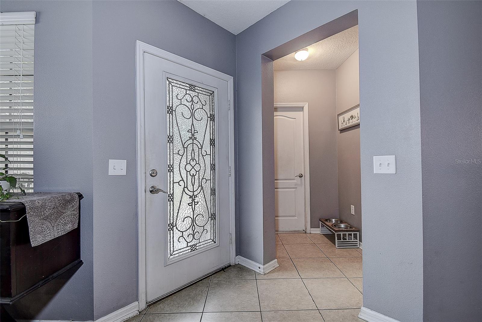 Front entry way.  Hallway leads to garage, laundry room and half bath