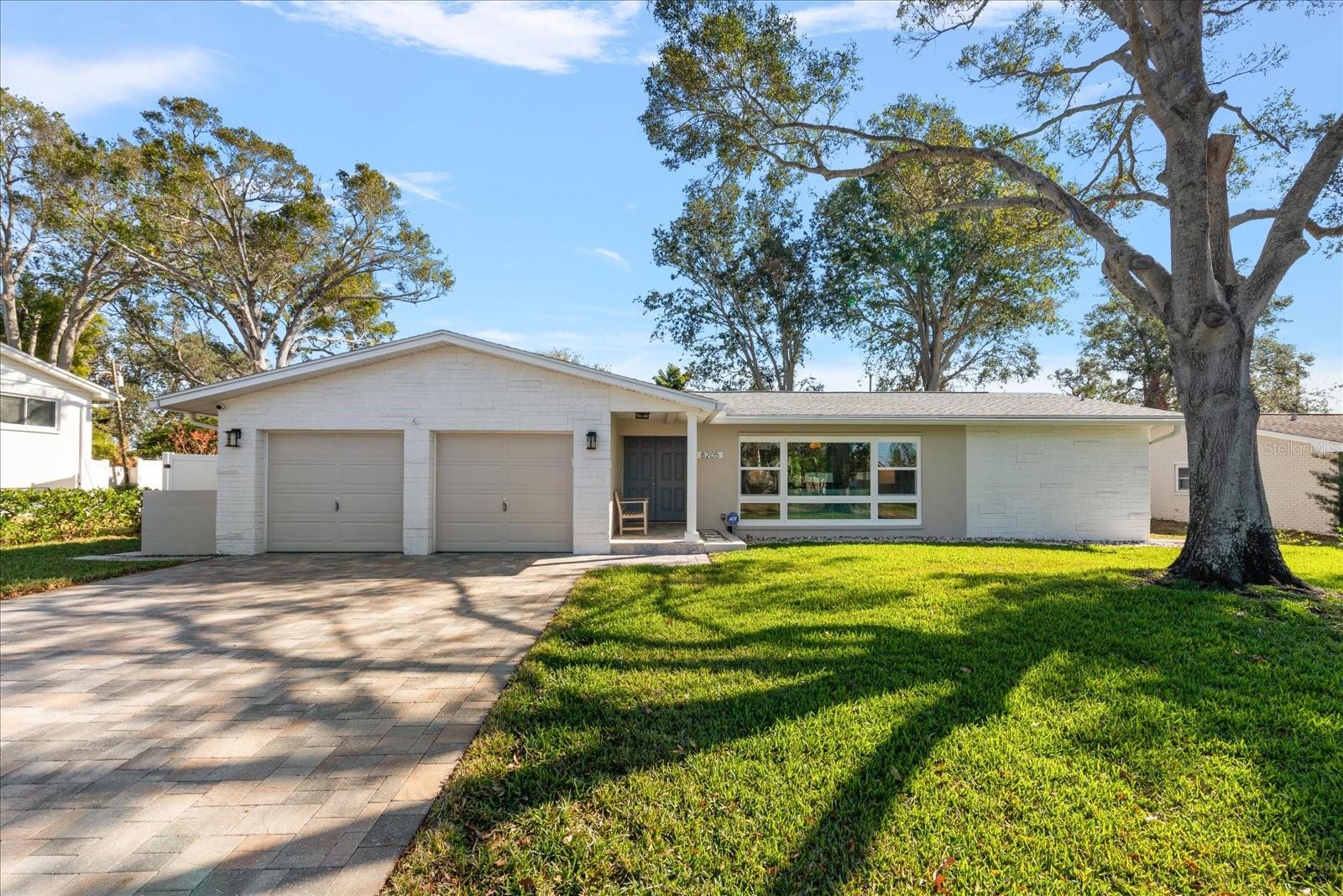 Front of the home. Paver driveway, 2-car garage, large private lot.