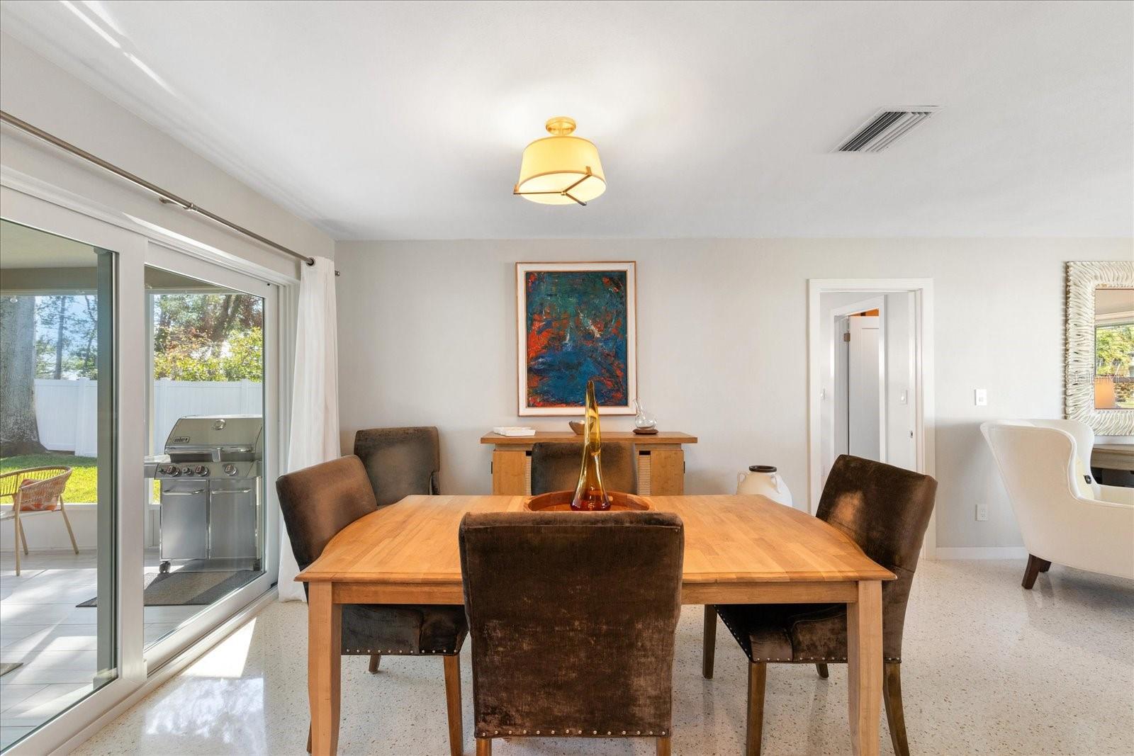 Dining room space bathed in natural light and views of the private backyard.