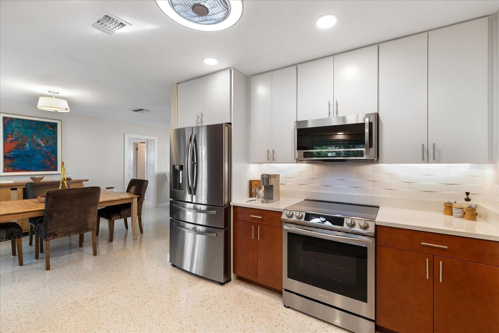 Updated kitchen with custom solid-wood soft-close cabinetry, quartz countertops, and stainless steel appliances.