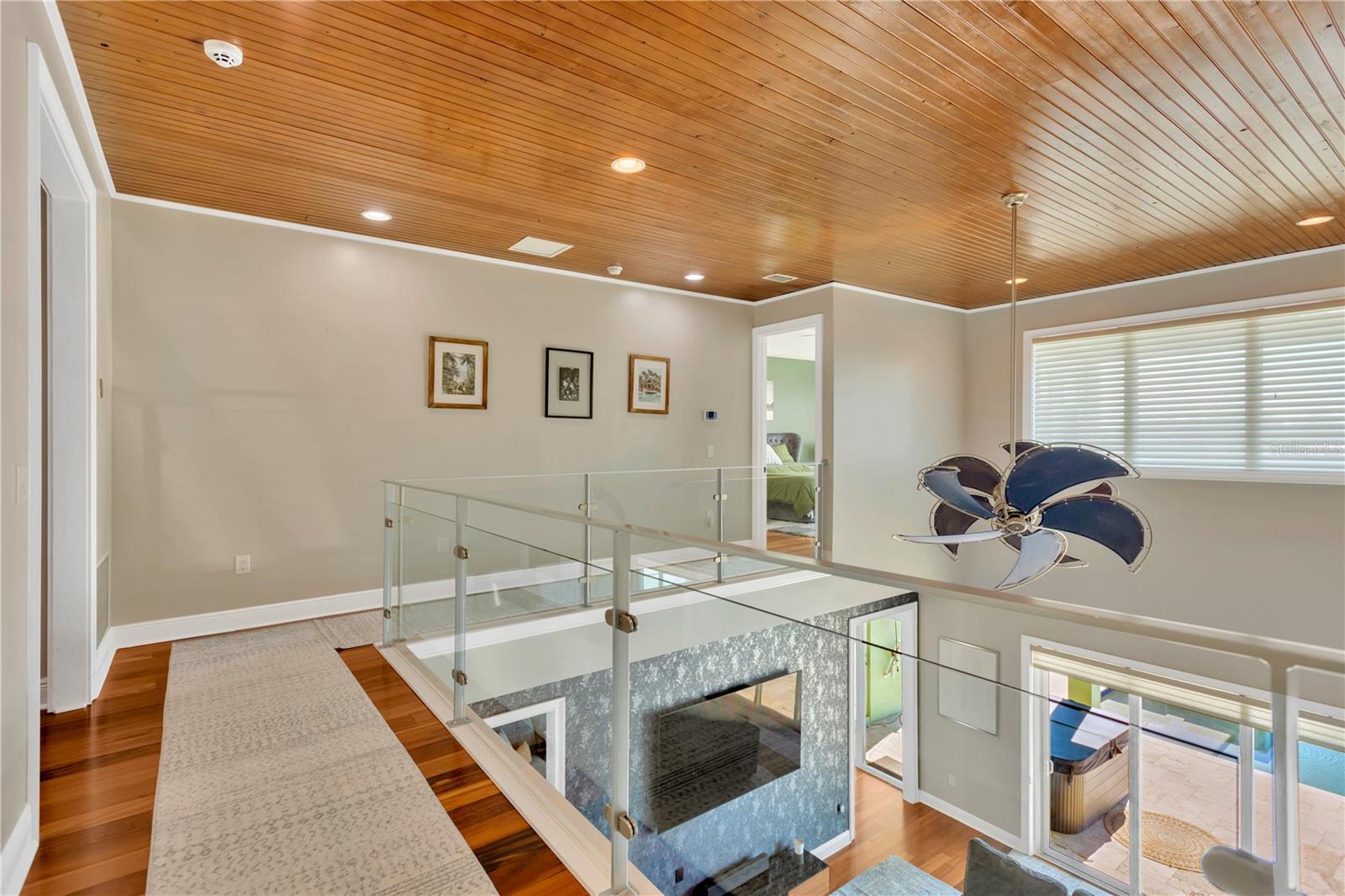 Upstairs Loft Area! Wood Bead Board Ceiling Accent & Clear Glass Railings For Views Below!