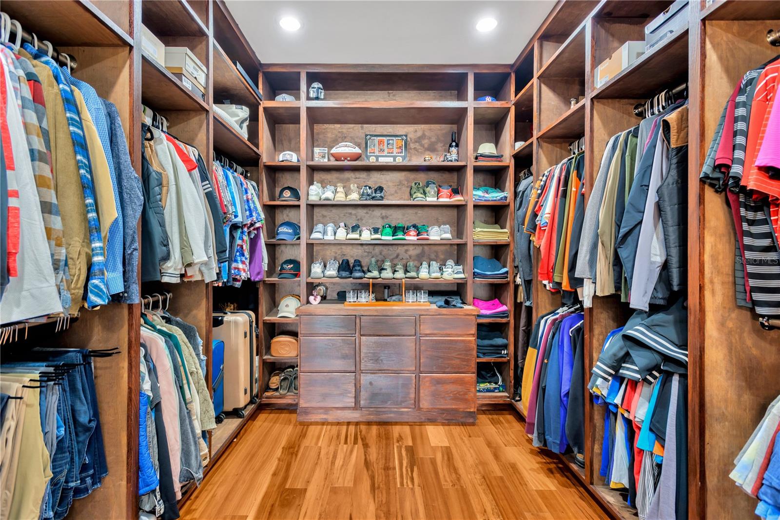 Primary Bedroom's Sweeping Walk-In Closet With Wall-To-Wall Custom Closet Organizer!