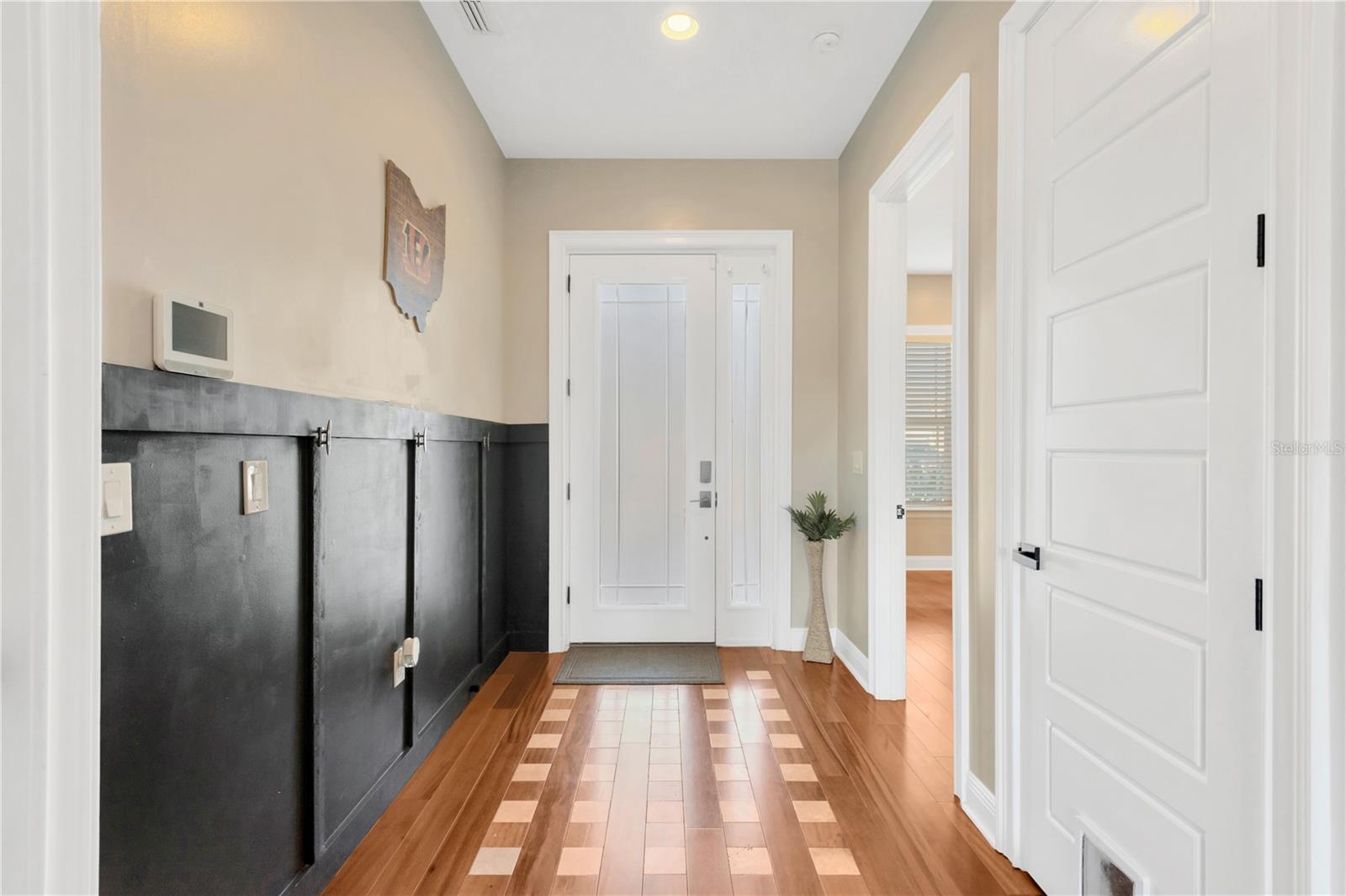 Inviting Foyer With Designer Wood Floor In-Lay and Decorative Entry "Coat/Bag Hanging" Wall Addition!