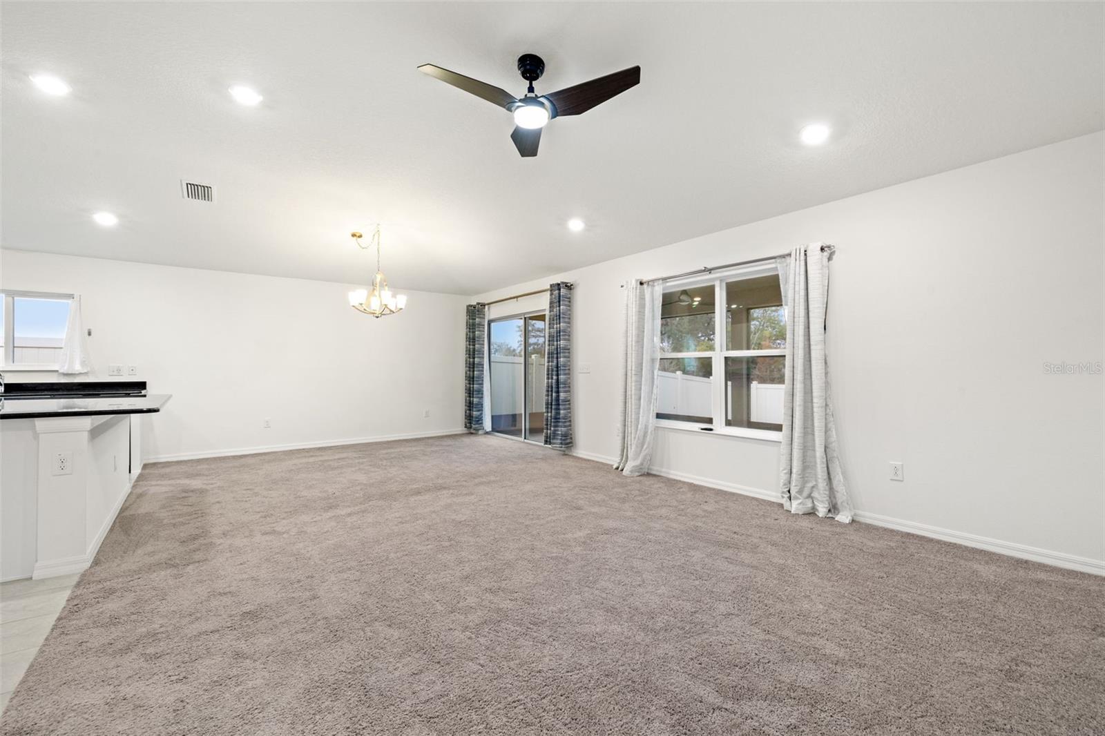 Living/dining area with vaulted ceiling