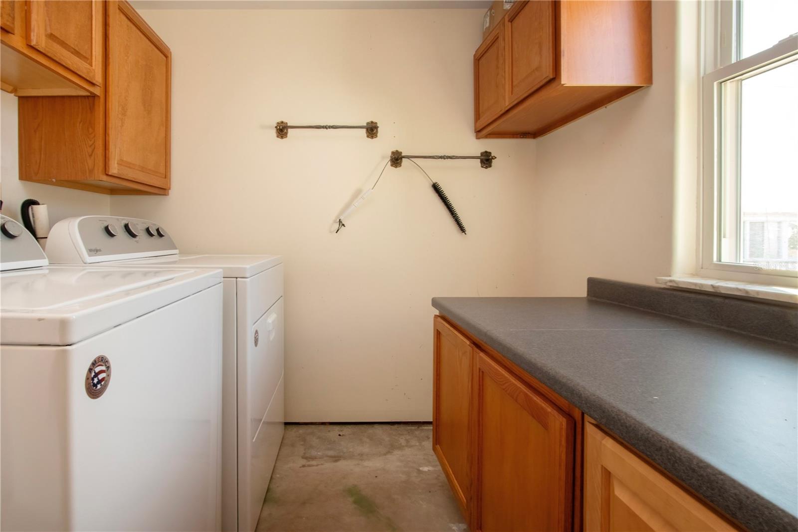 Inside Laundry room w/Washer & Dryer, Storage Cabinets & Counter to Fold clothes