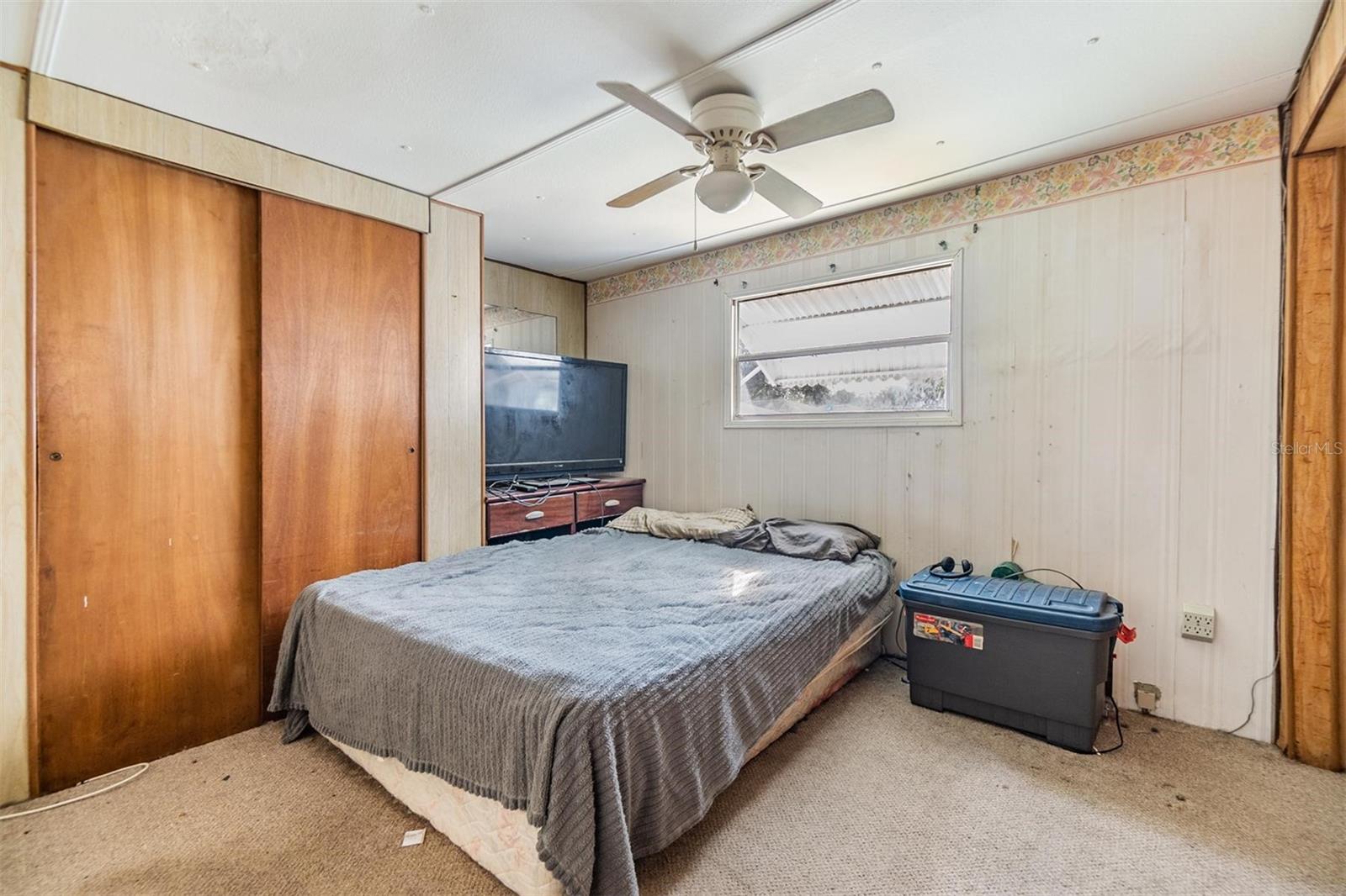 Bedroom 2 with a wall of drawers and closets